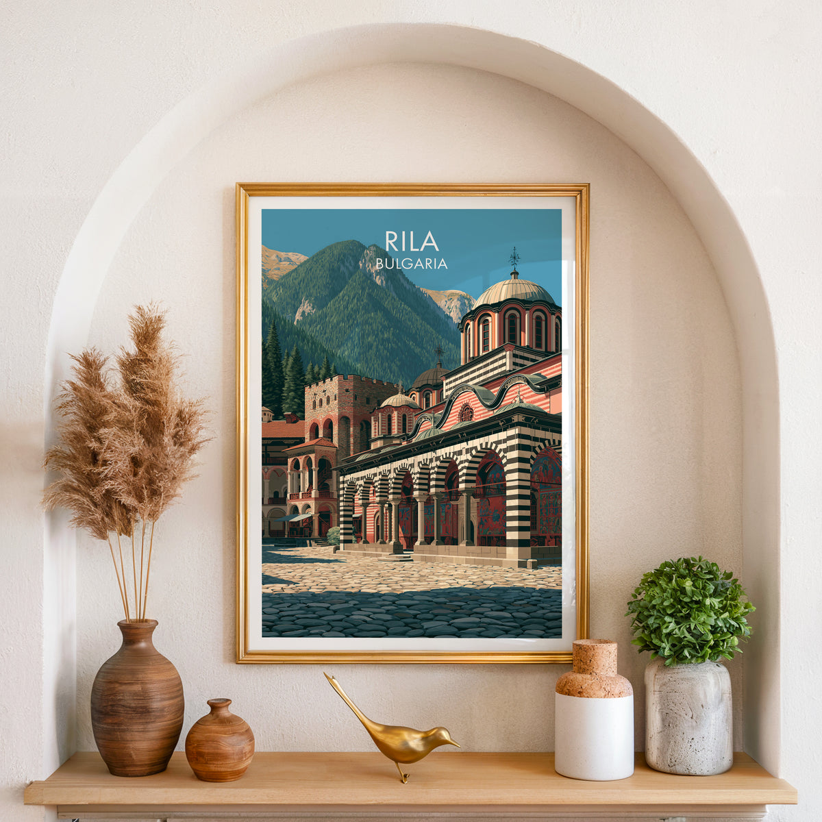 Rila mountain courtyard poster, gold frame in an arched wall niche above pampas grass in a clay vase