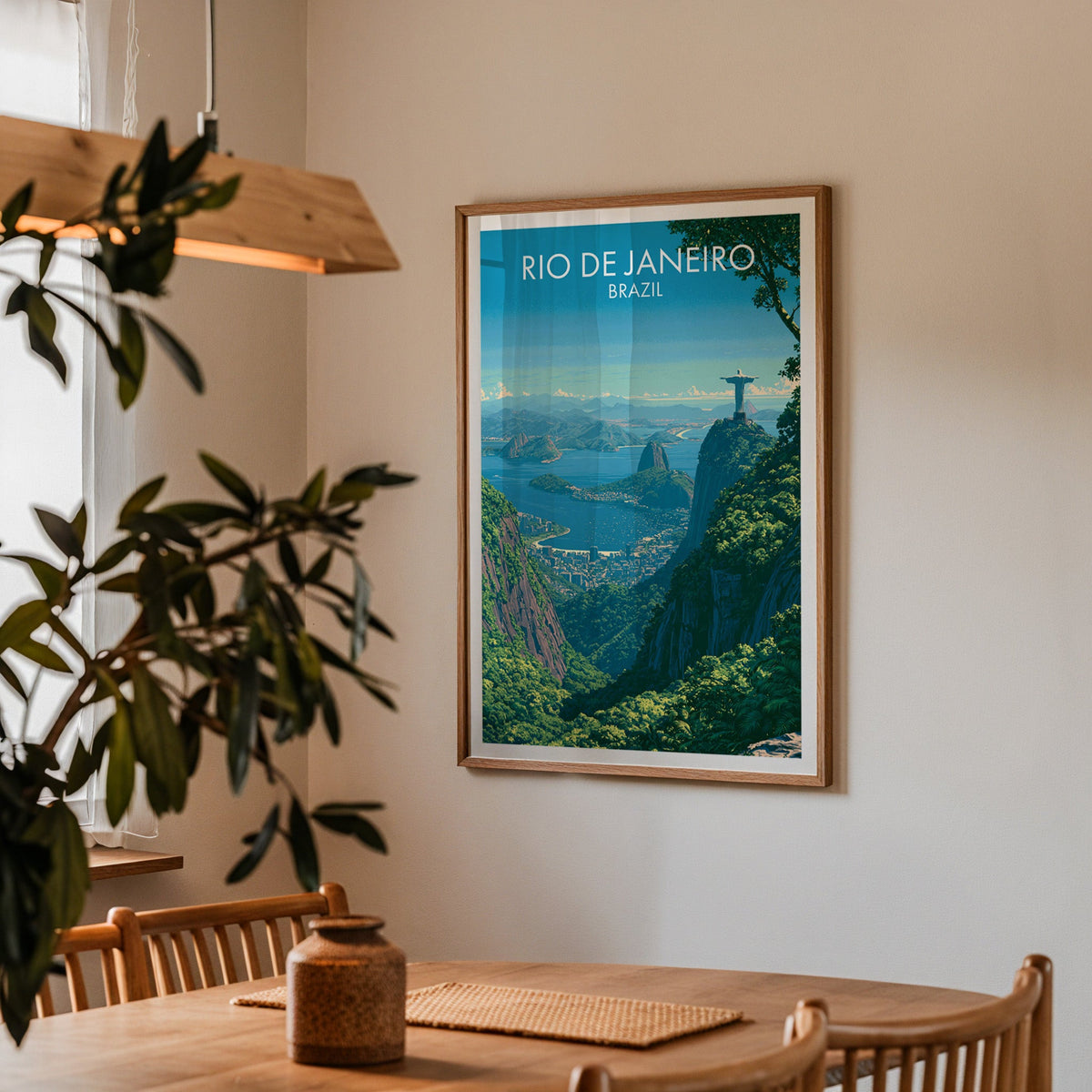 Rio de Janeiro bay poster in an oak frame in a dining corner with a wood table, slat chairs and a pendant lamp