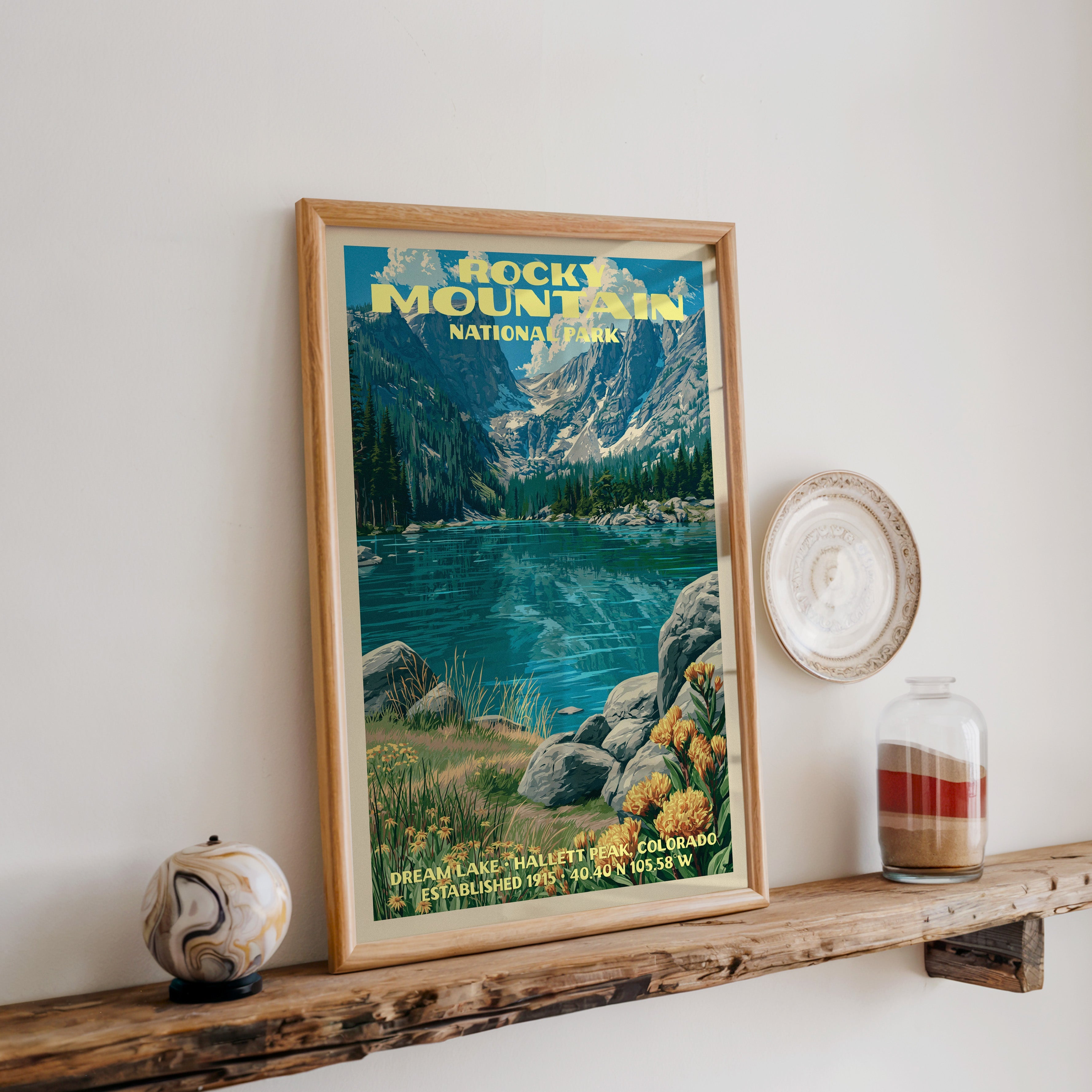 Rocky Mountain Dream Lake print in oak, leaning on a reclaimed wood ledge with a stone sphere and sand jar
