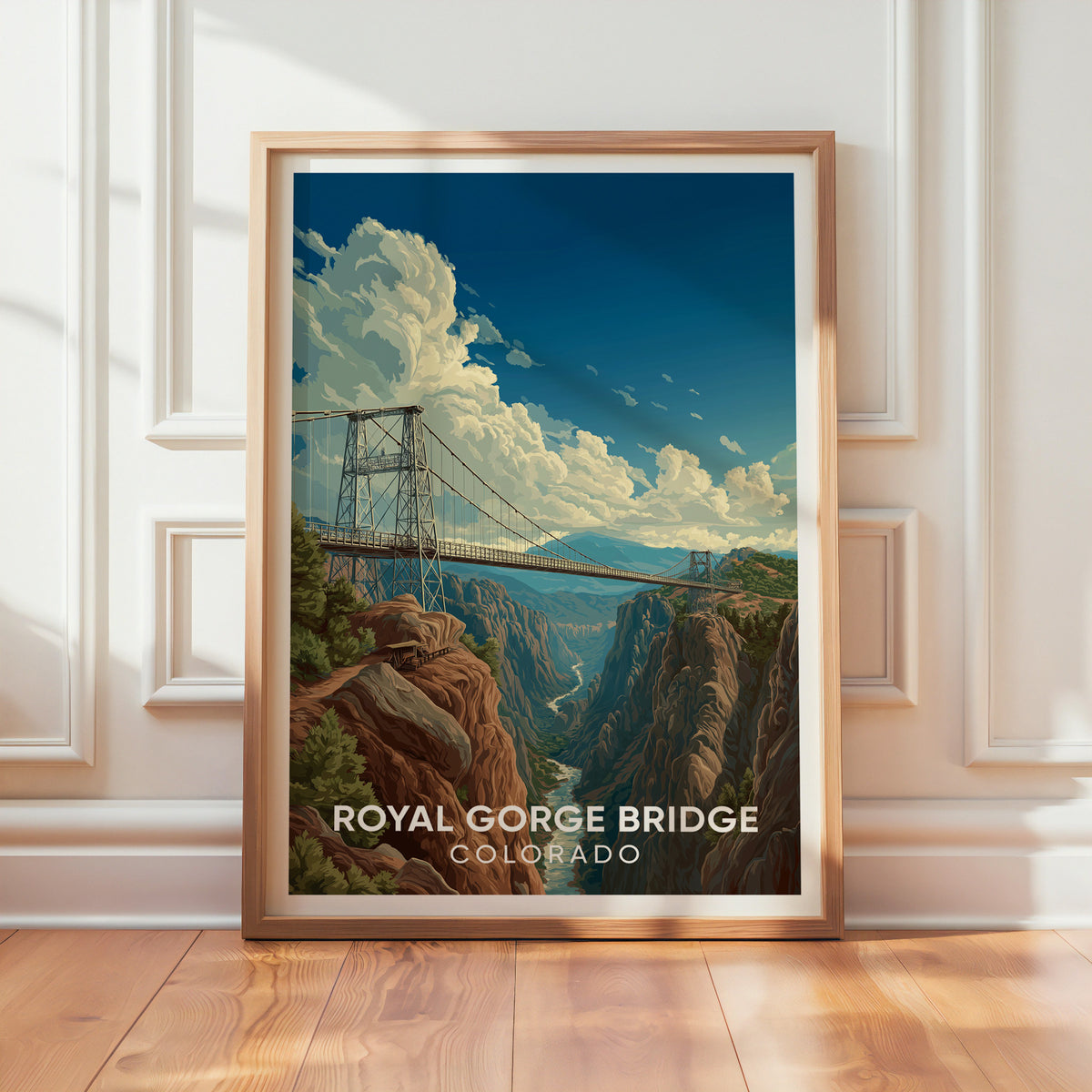 Royal Gorge Bridge print in oak leaning on a panelled white wall with sun across the wood floor