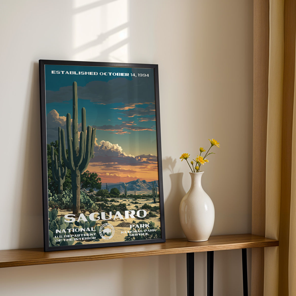 Saguaro National Park travel poster leaning on a console table with a vase of yellow flowers