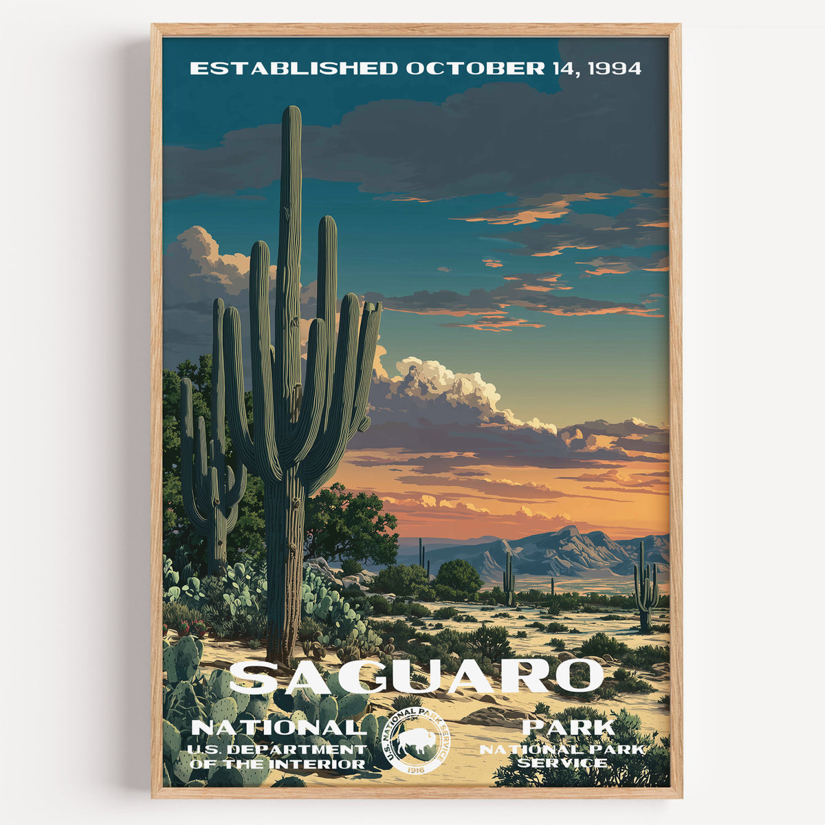 Saguaro National Park vintage travel poster in a wood frame, saguaro cacti standing against a burning orange desert sunset