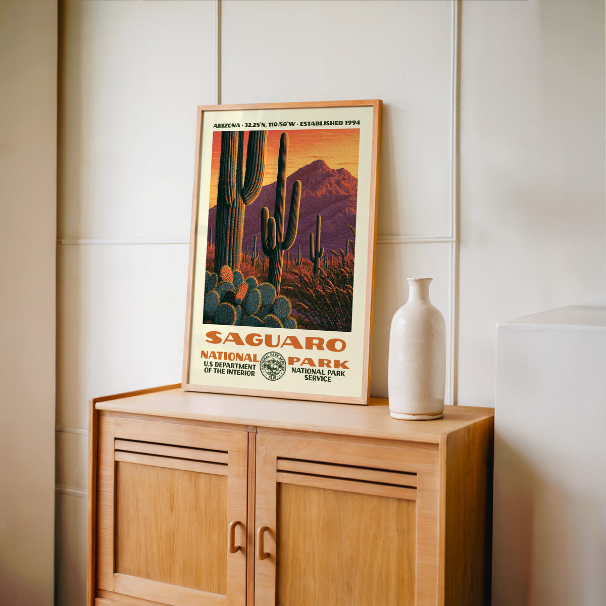 Saguaro National Park WPA print framed in light oak on a wooden sideboard with a ceramic vase
