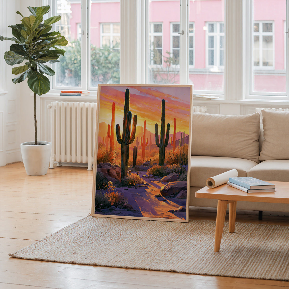 Saguaro National Park watercolor art print leaning against a living room wall beside a linen sofa and coffee table