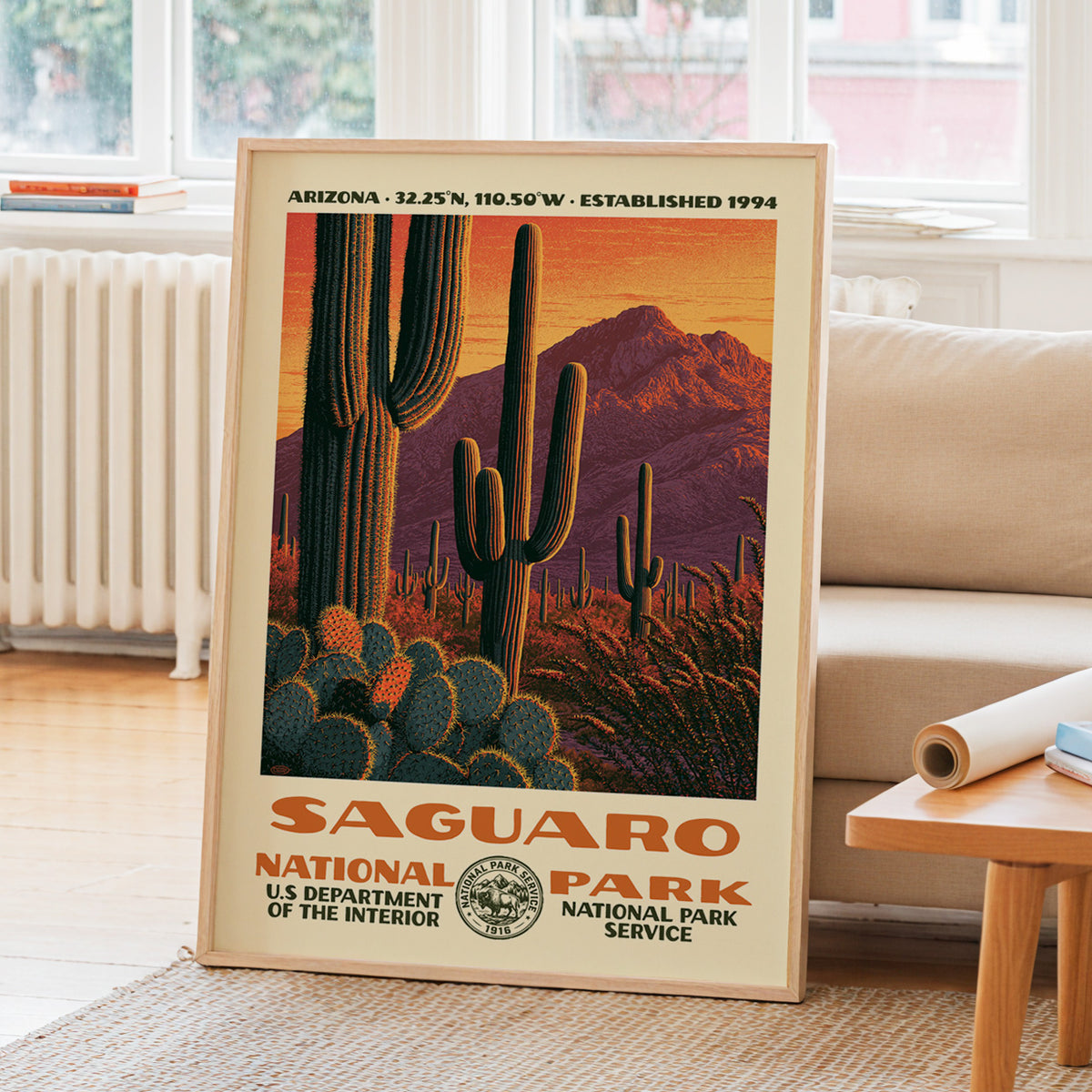Saguaro National Park WPA travel poster leaning on a sunlit living room wall beside a linen sofa