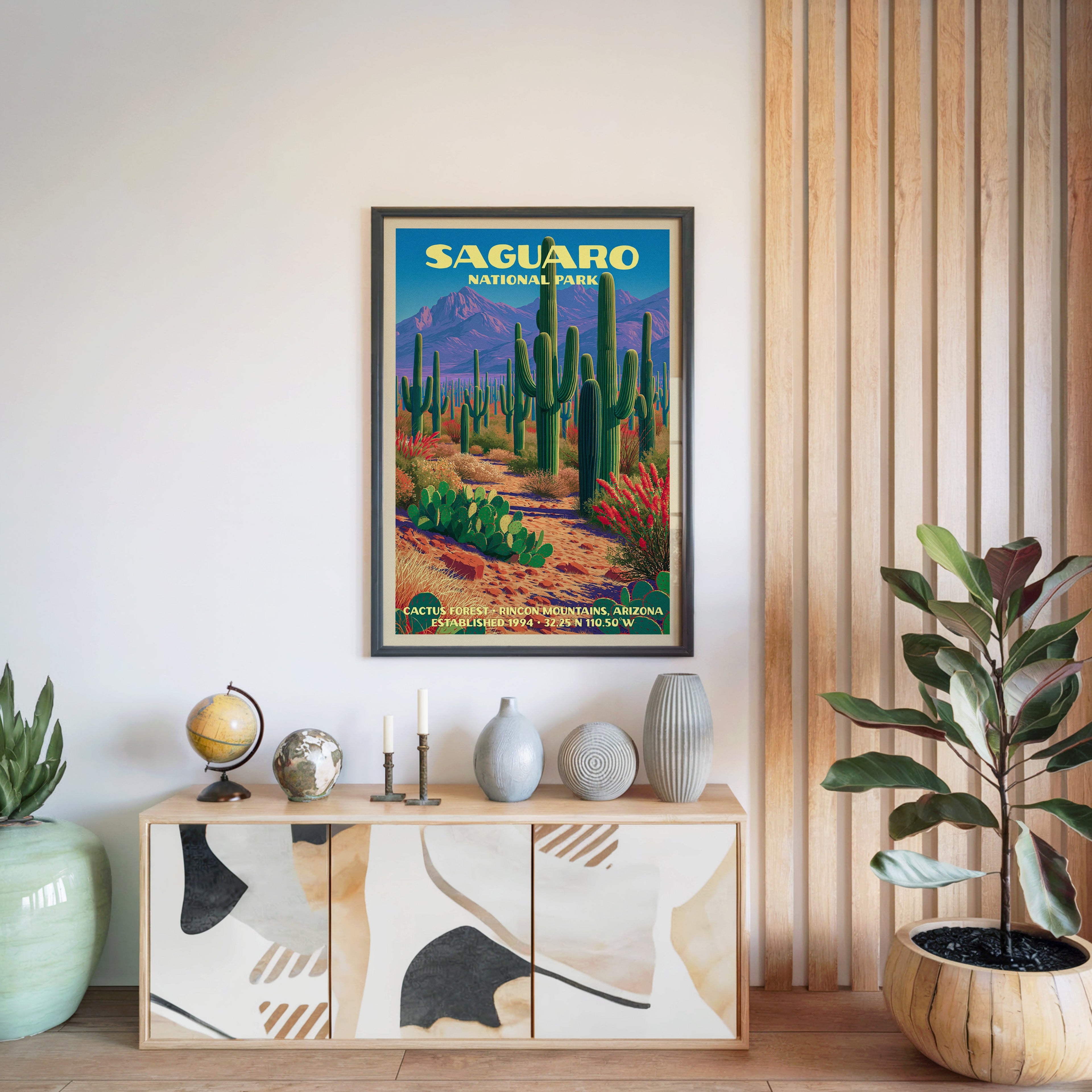 Saguaro National Park print in a black frame above a light wood sideboard by a slatted wall panel