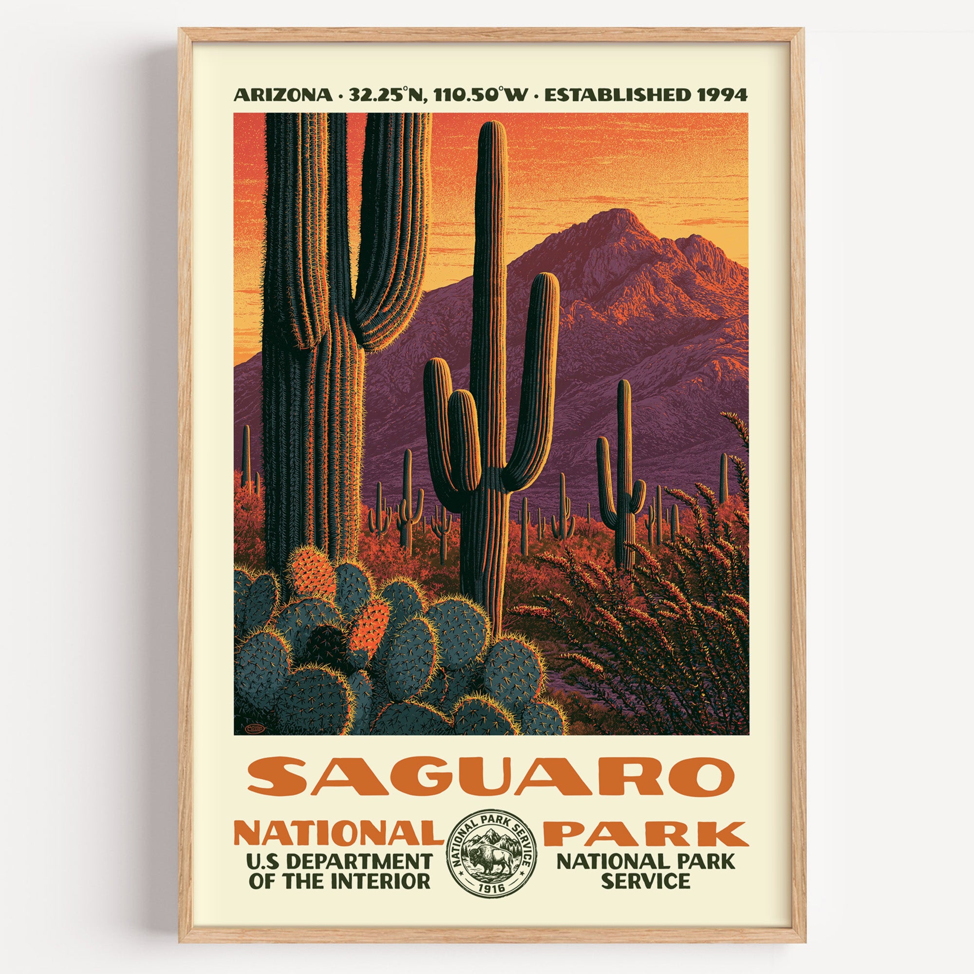 Saguaro National Park vintage WPA poster in a wood frame, towering saguaro cactus silhouetted against a blazing desert sunset