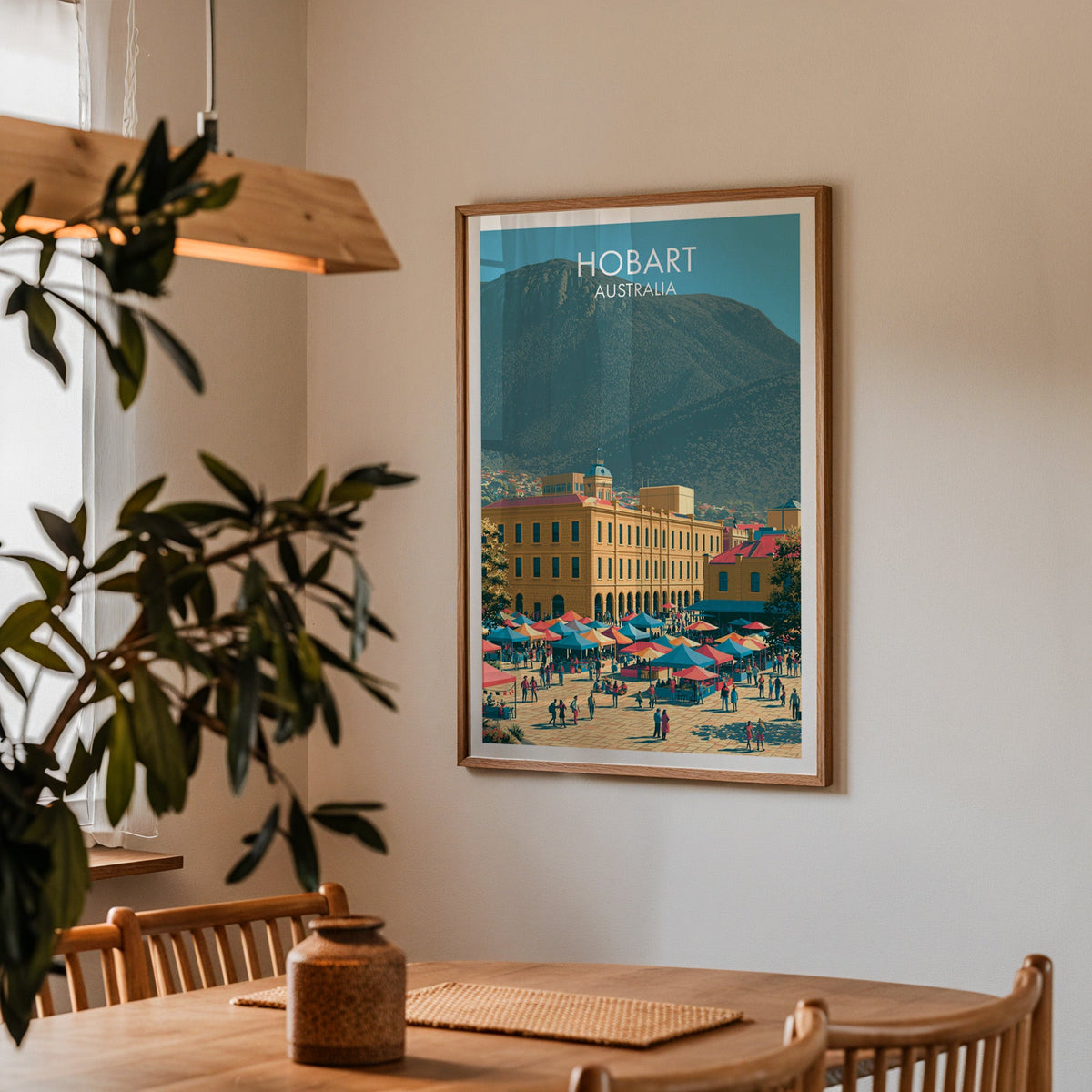 Hobart poster in an oak frame in a dining corner with an oak table, spindle chairs and pendant light