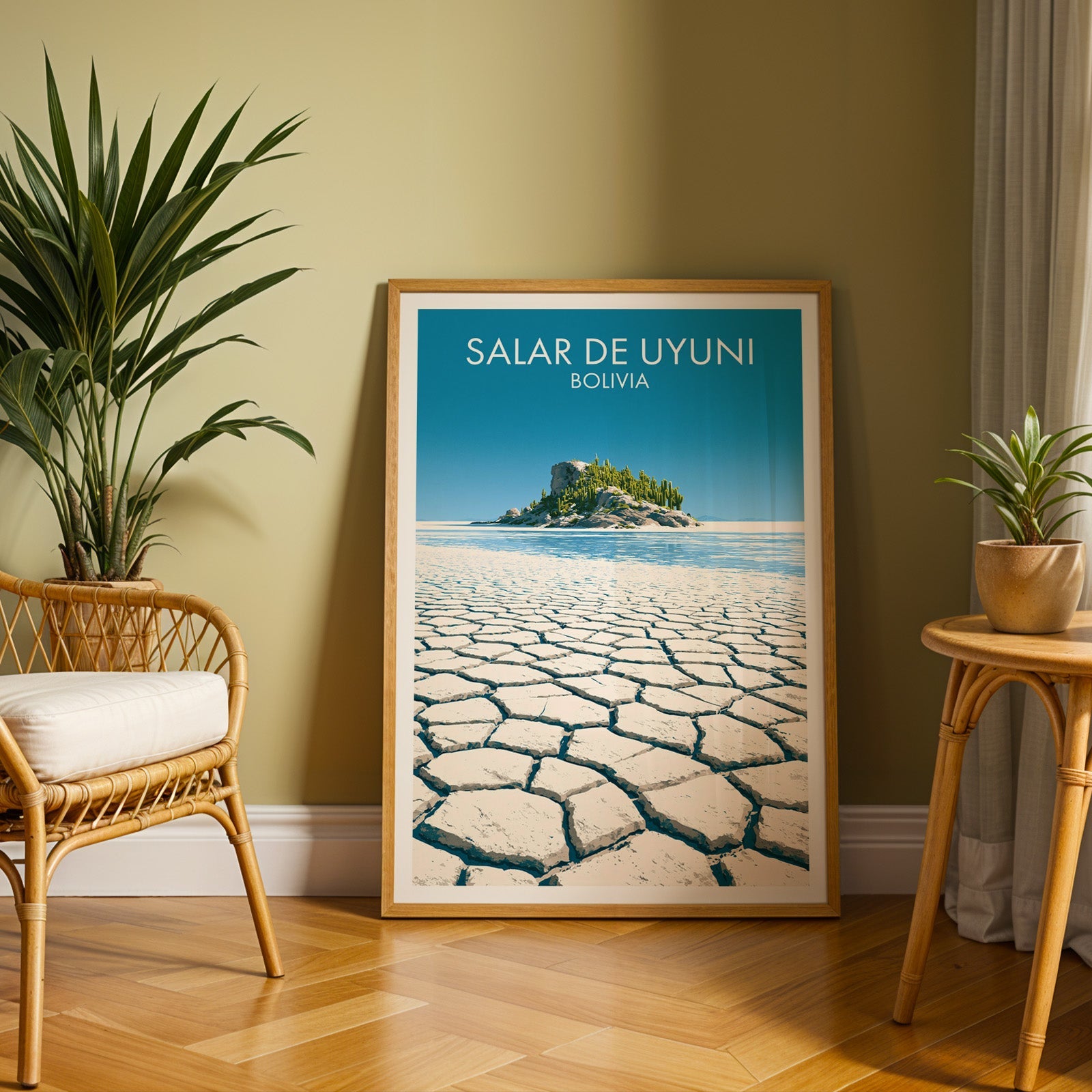 Uyuni desert artwork in an oak frame on a herringbone floor against an olive wall with a rattan chair and tall palm