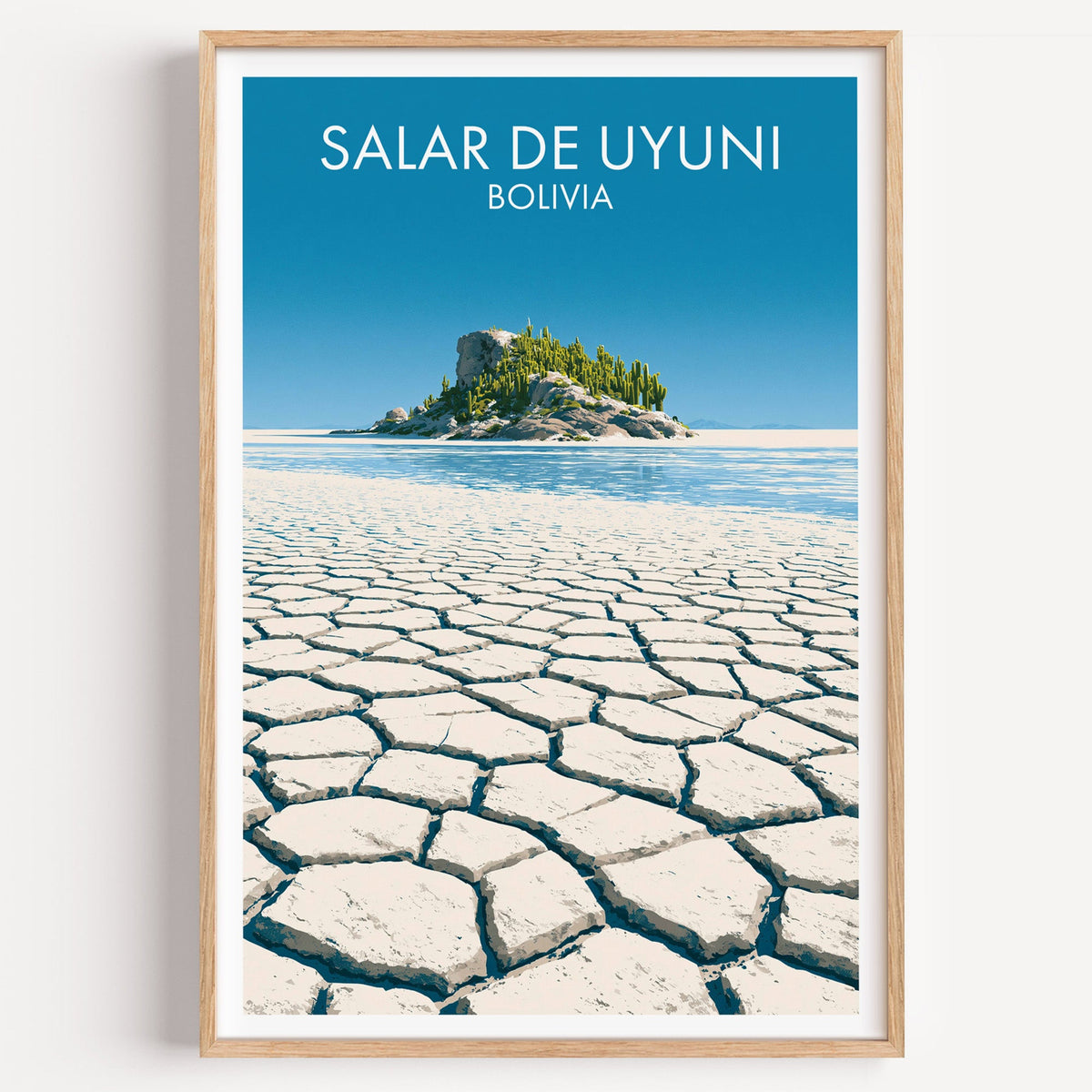Salar de Uyuni salt flat print with a cactus island in a light oak frame on a plain white wall