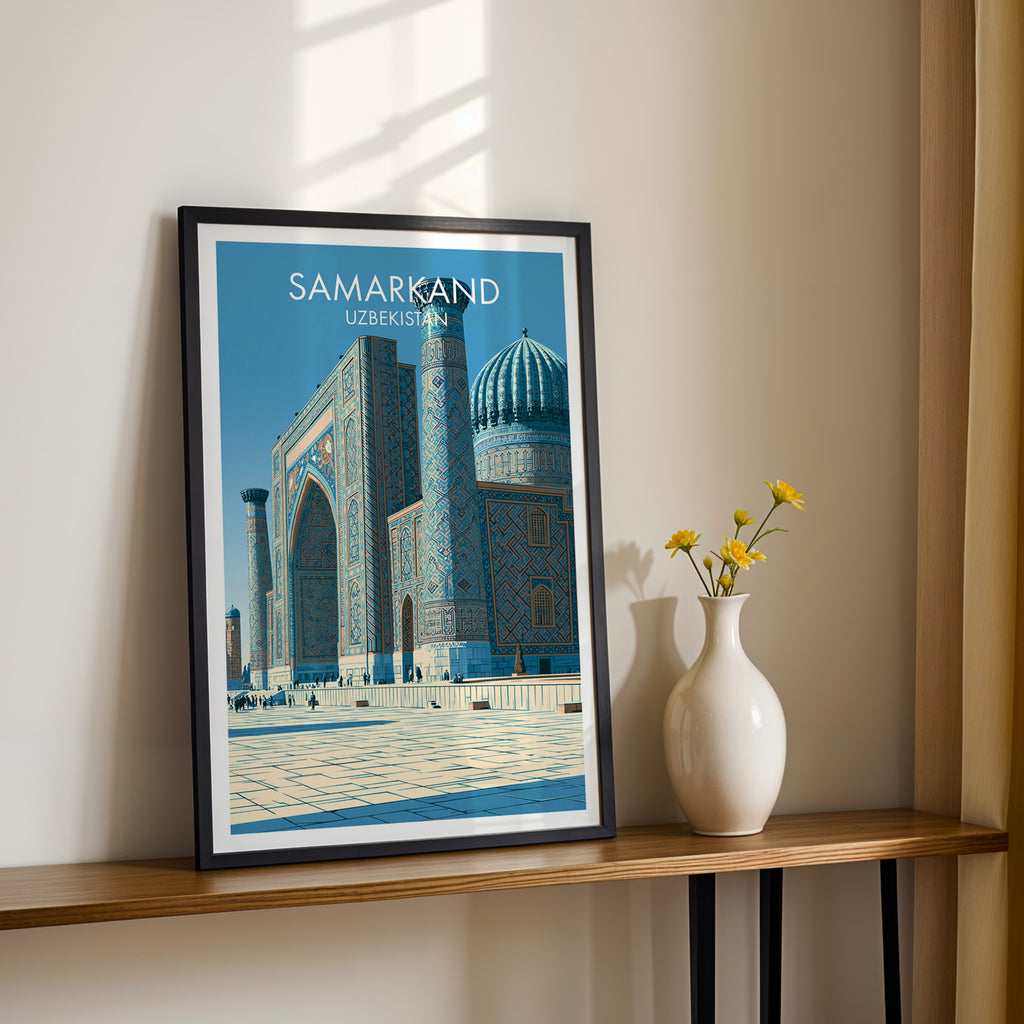 Black framed Samarkand Uzbekistan print on a narrow hallway console in sunlight, styled with yellow flowers