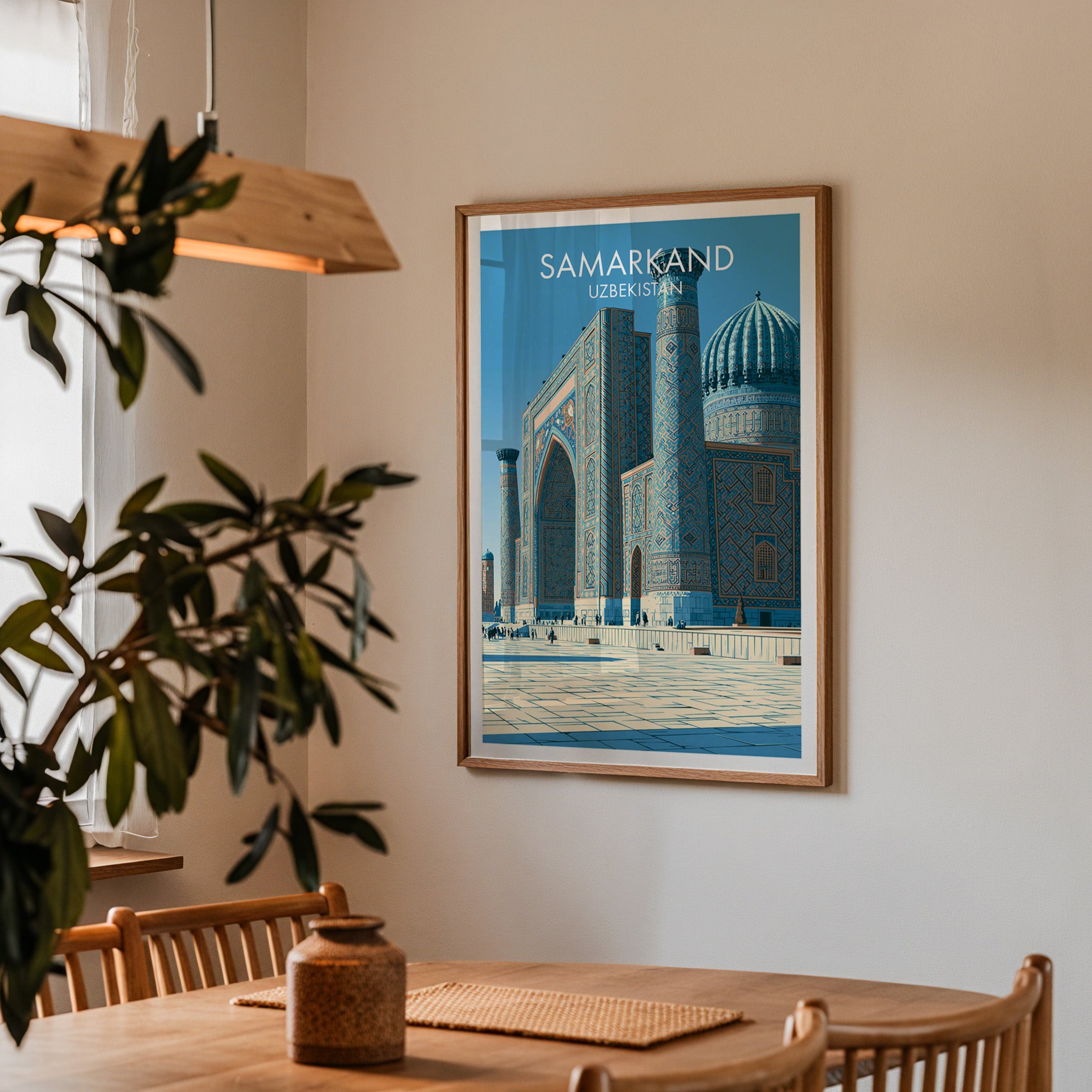 Framed Samarkand Uzbekistan print on a dining room wall above an oak table in warm afternoon light