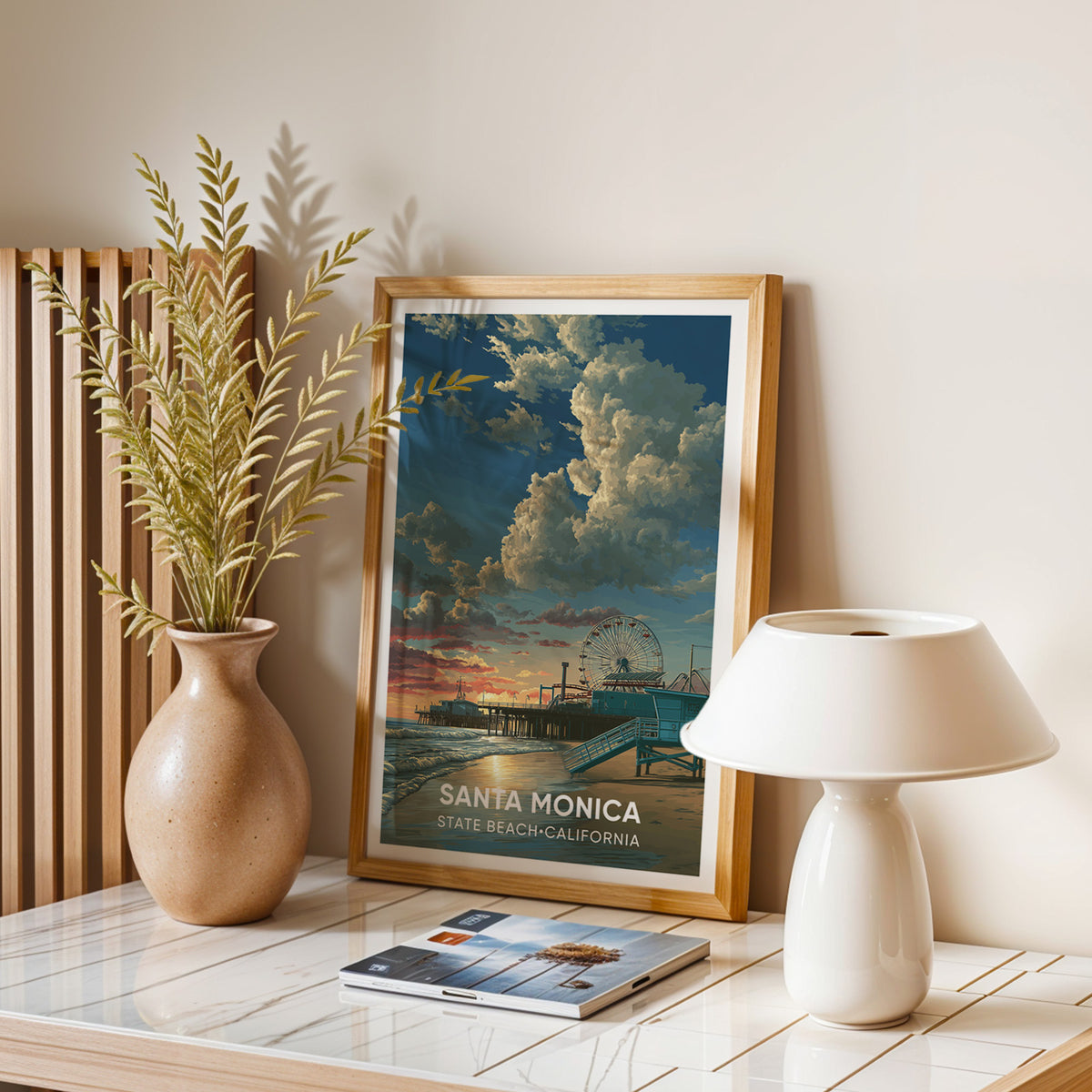 California sunset beach print in oak on a balanced stone table with a dome lamp, magazines and dry leaves