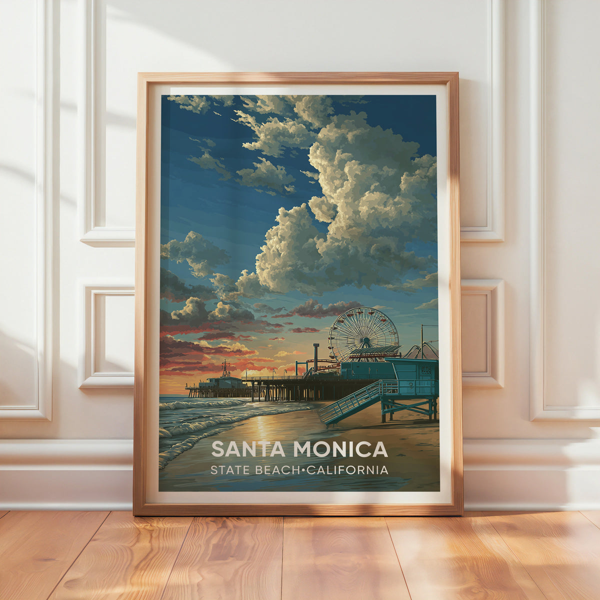 Santa Monica beach sunset poster in oak leaning on a textured white wall, daylight falling across the boards