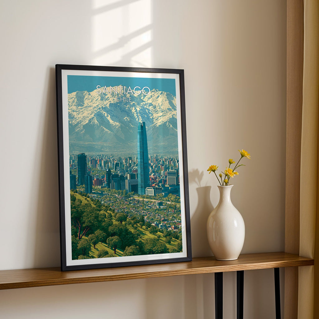 Chilean capital wall art in a black frame on a narrow wood shelf with black iron legs and yellow daisies in sunlight