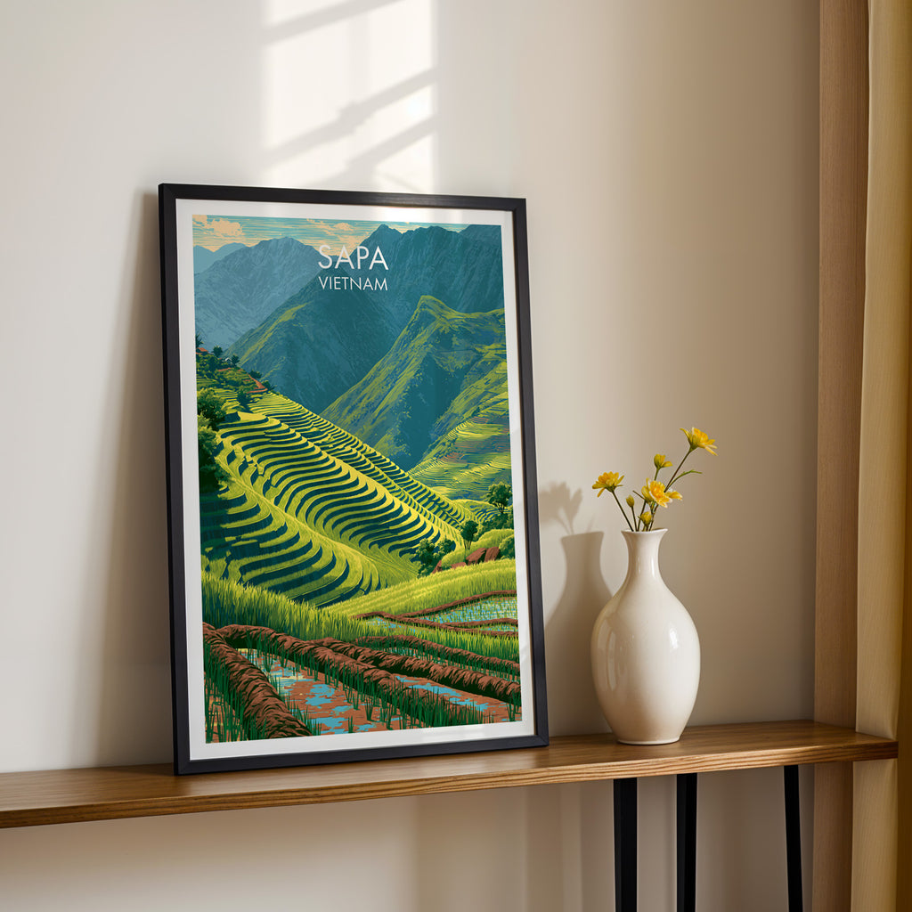 Black framed Sapa Vietnam print on a narrow hallway console in sunlight, styled with yellow flowers