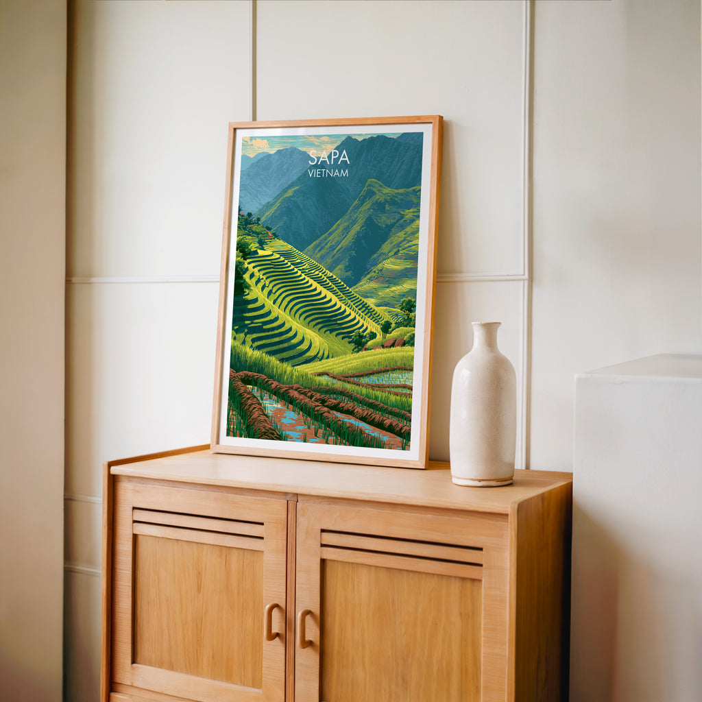 Small Sapa Vietnam travel poster in an oak frame on a mid-century sideboard with a ceramic vase