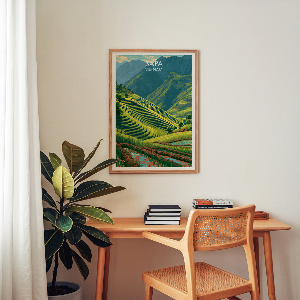 Sapa Vietnam wall art above a wooden home office desk with a rattan chair and books