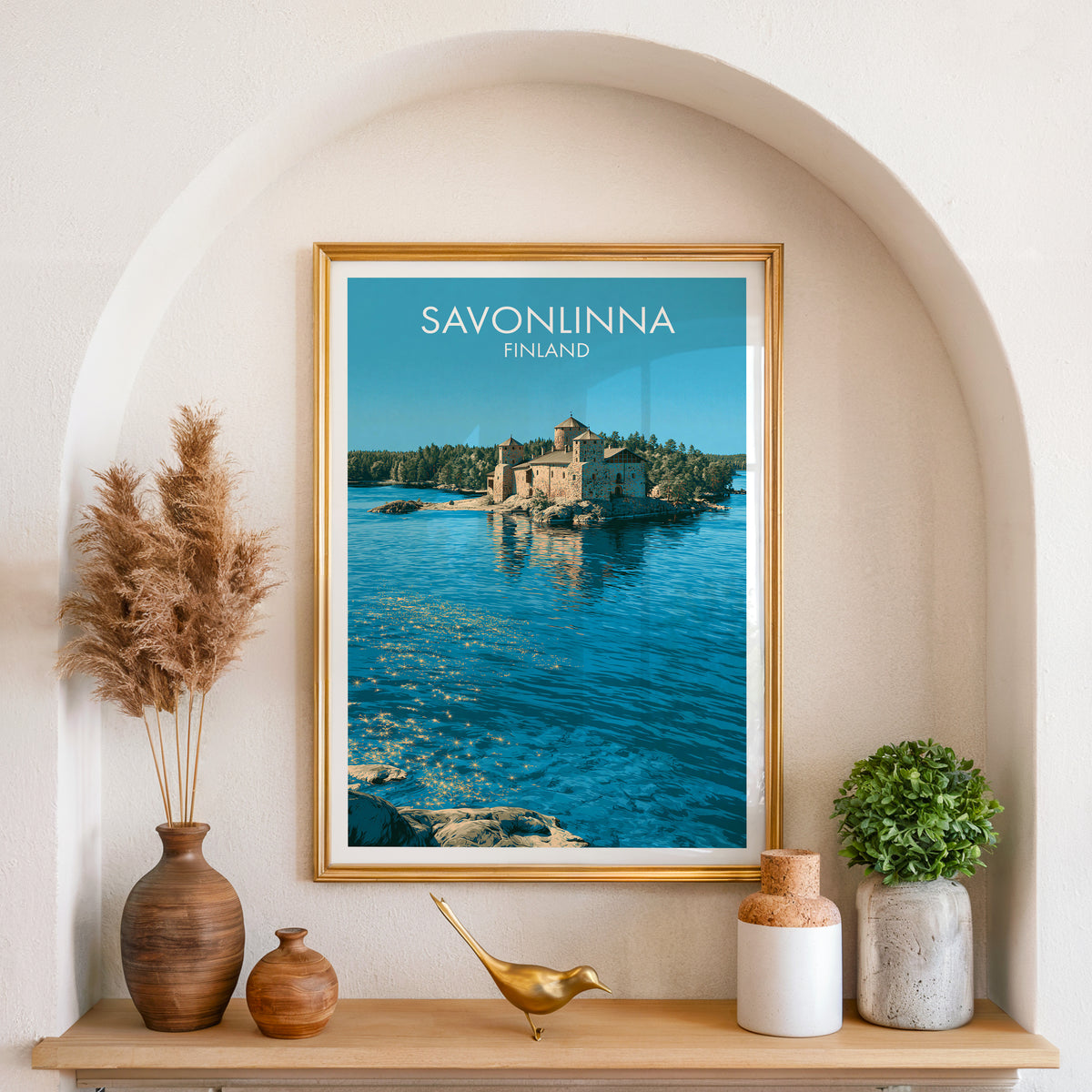 Savonlinna Finland wall art, gold frame in an arched wall niche above pampas grass in a clay vase