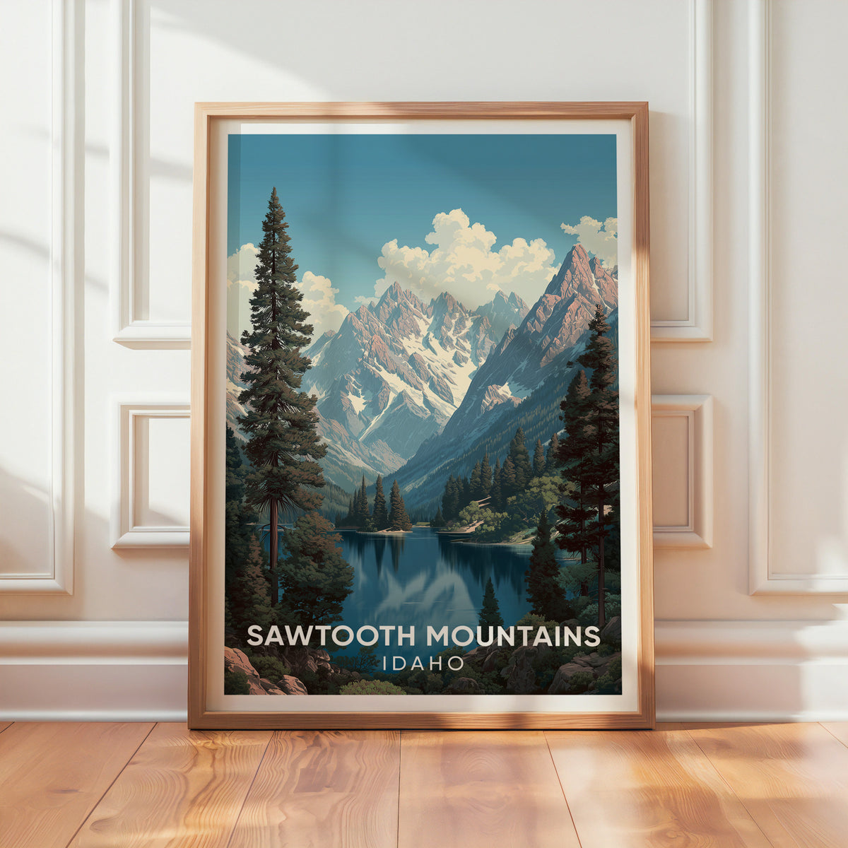 Sawtooth Mountains poster in an oak frame propped on a textured white wall, sun stripes on the wood floor