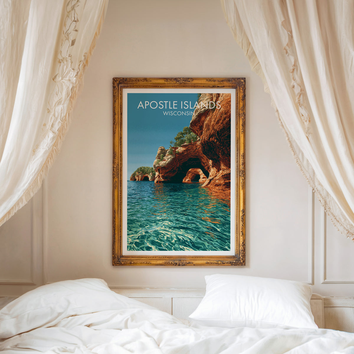 Apostle Islands print in a carved gold frame above a white bed with a linen canopy and moulded wall.