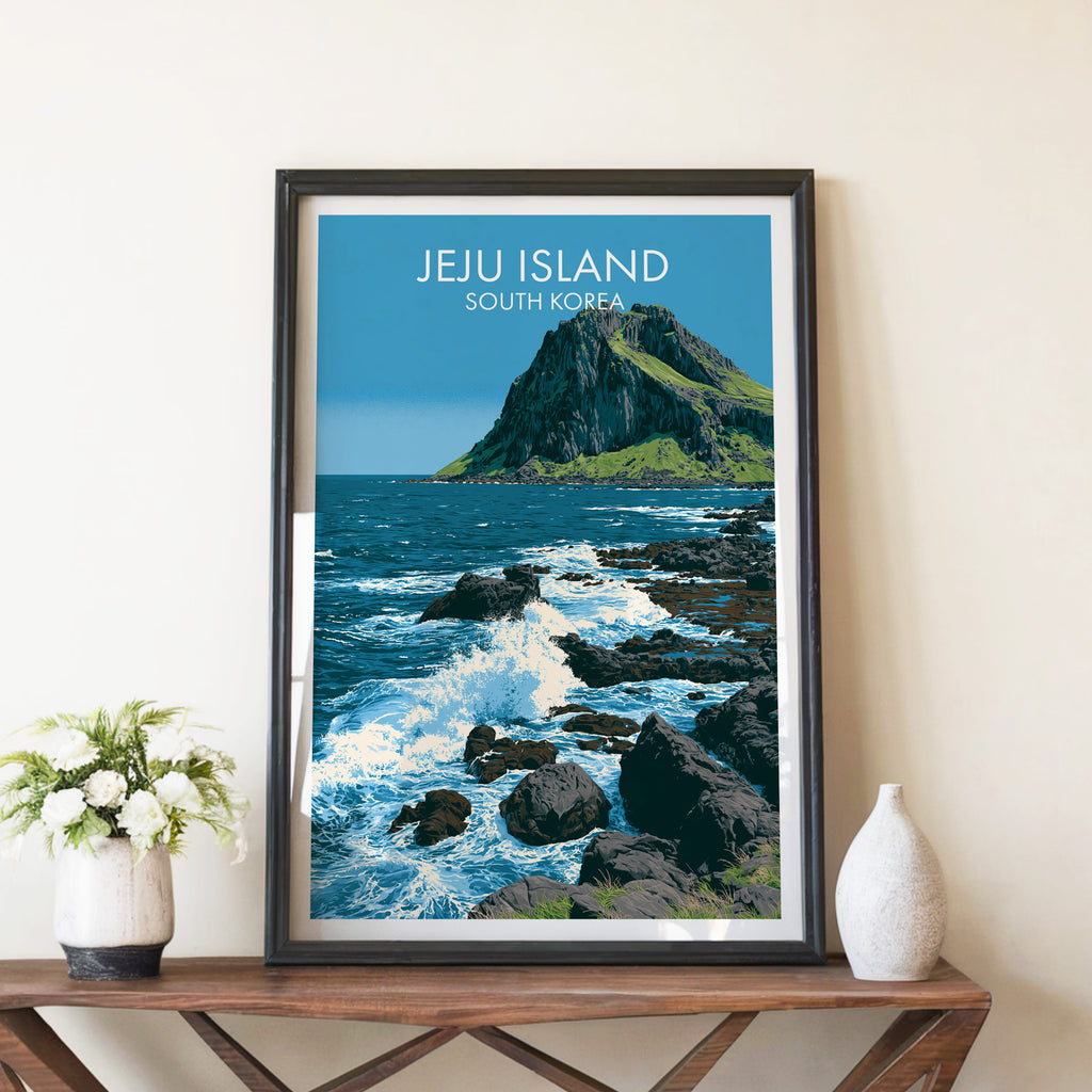 Seongsan Ilchulbong Jeju Korea travel poster in a black frame on a wooden console table with white flowers