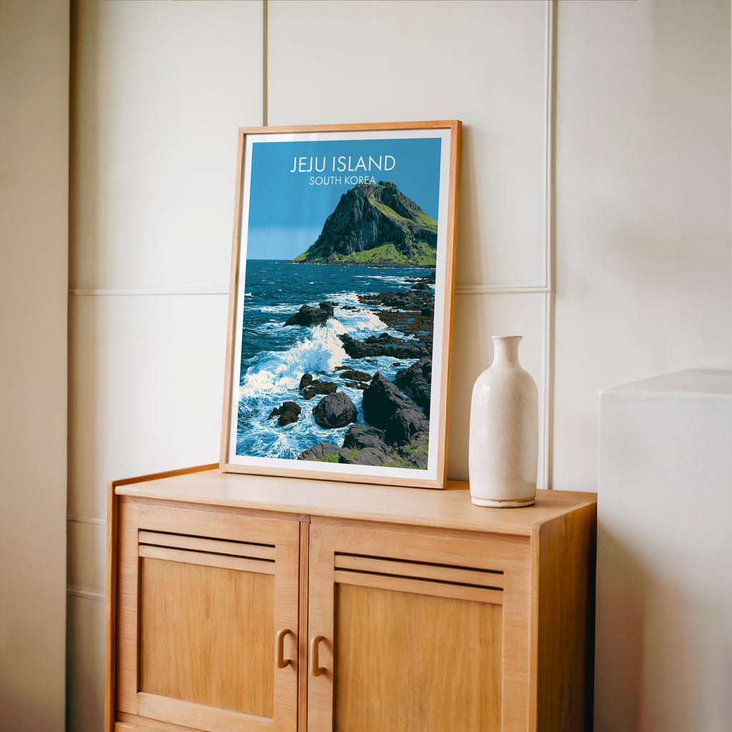 Small Seongsan Ilchulbong Jeju Korea travel poster in an oak frame on a mid-century sideboard with a ceramic vase