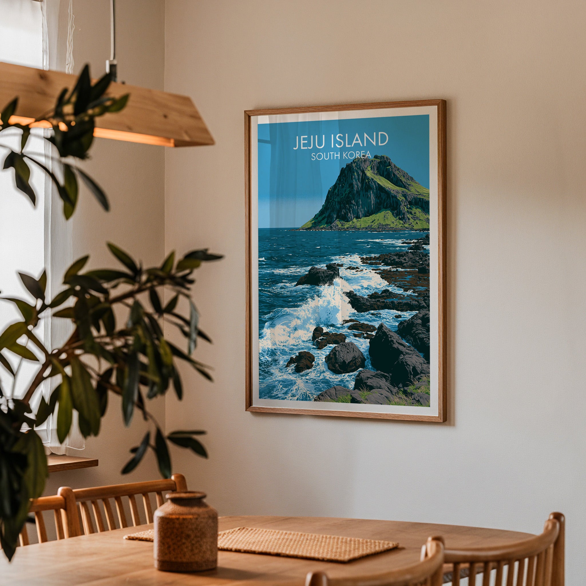 Framed Seongsan Ilchulbong Jeju Korea print on a dining room wall above an oak table in warm afternoon light