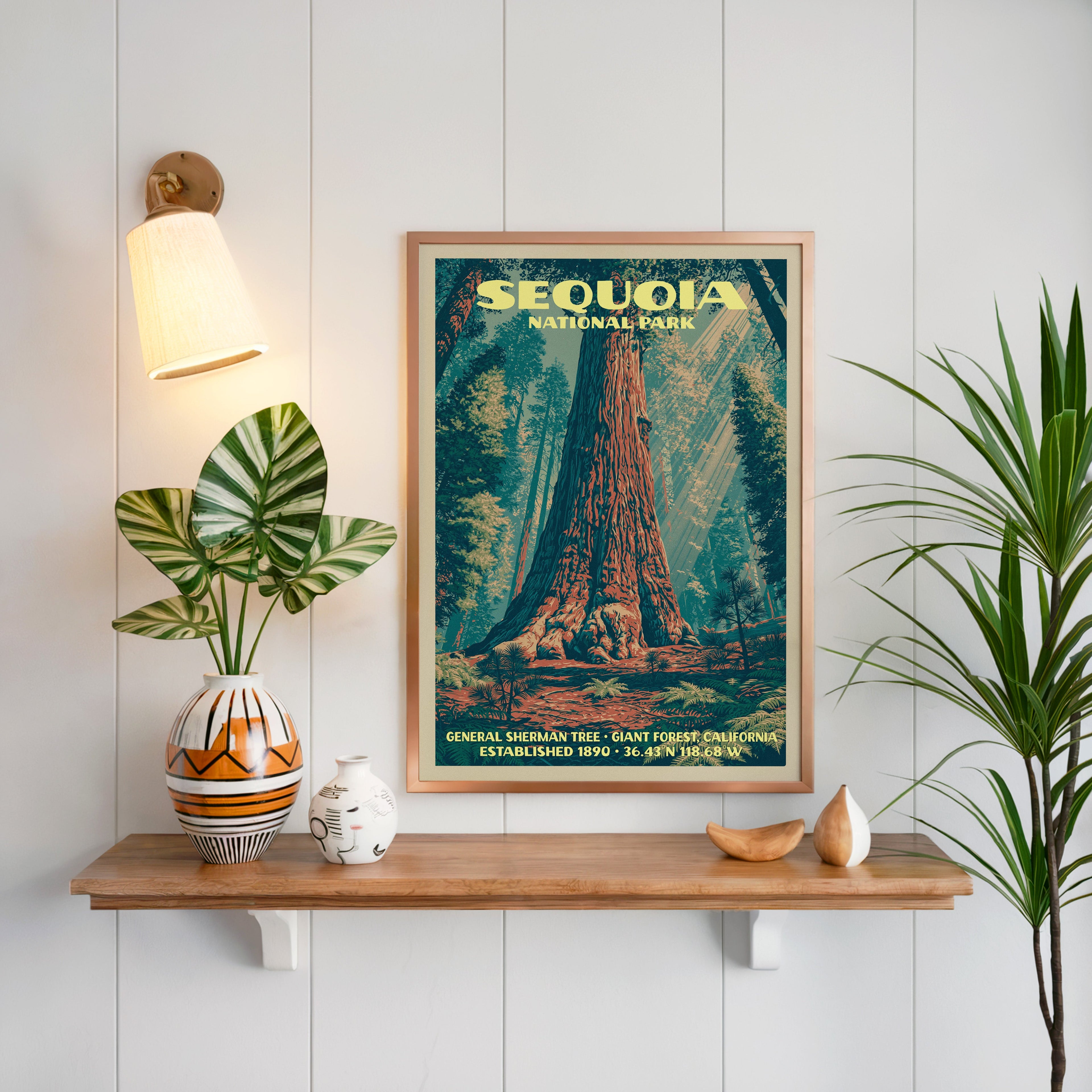 General Sherman Tree print framed on white panelling above an oak shelf with a patterned vase and sconce