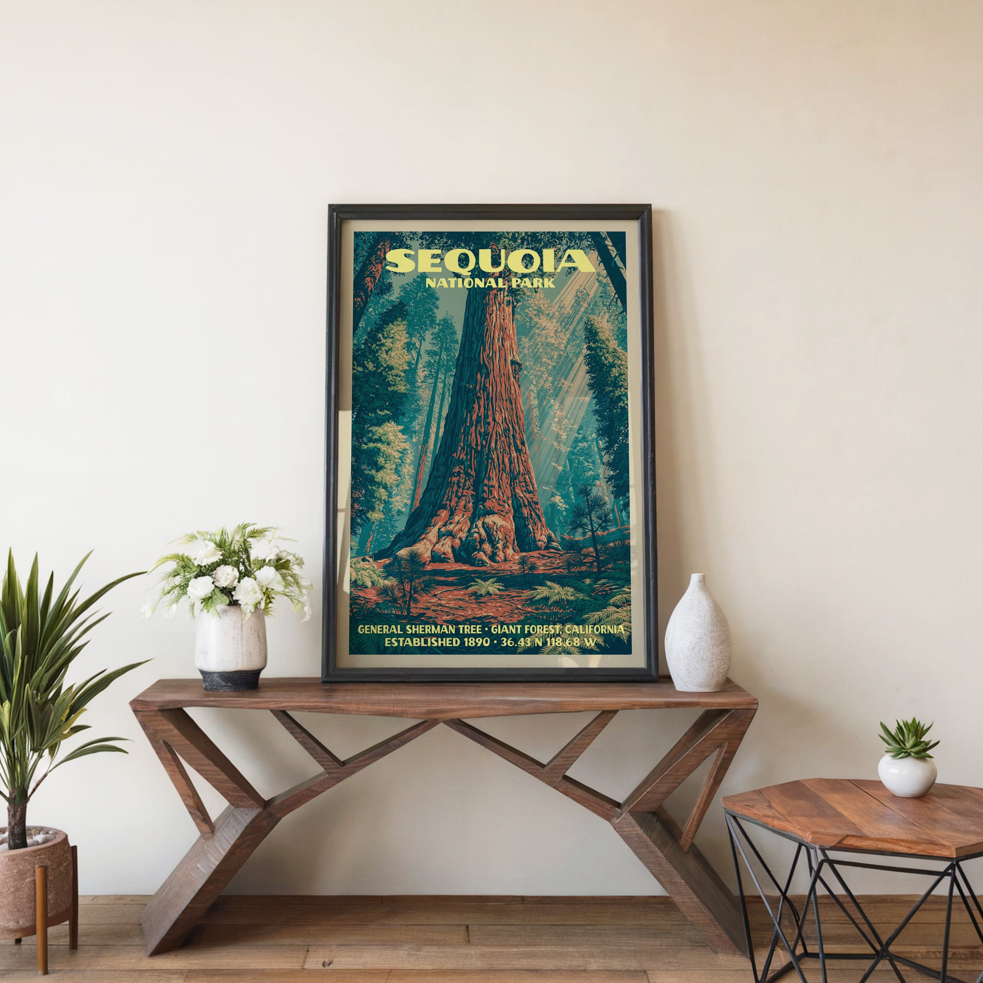 Sequoia General Sherman wall art in black, leaning on a walnut console with white anemones and a vase