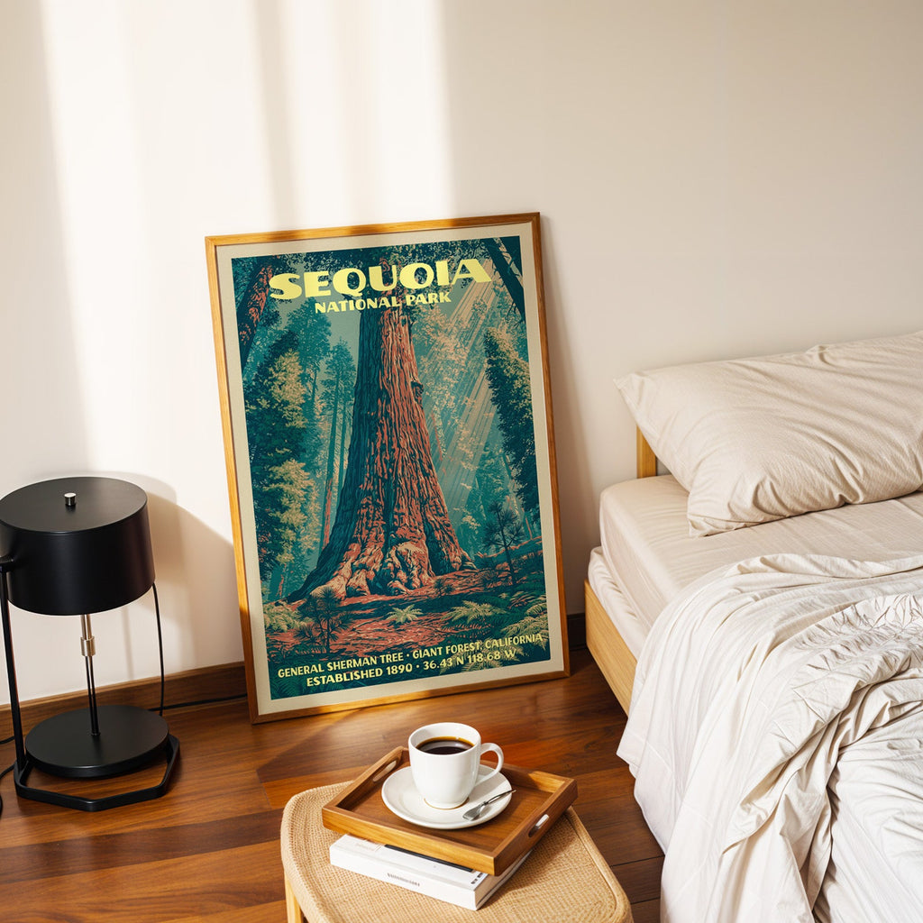 General Sherman Tree print in a gold frame on the floor beside a made bed and a black table lamp