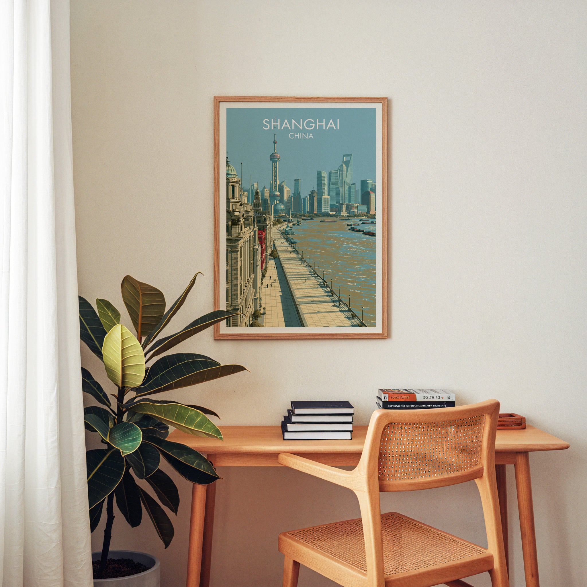 Shanghai China wall art above a wooden home office desk with a rattan chair and books
