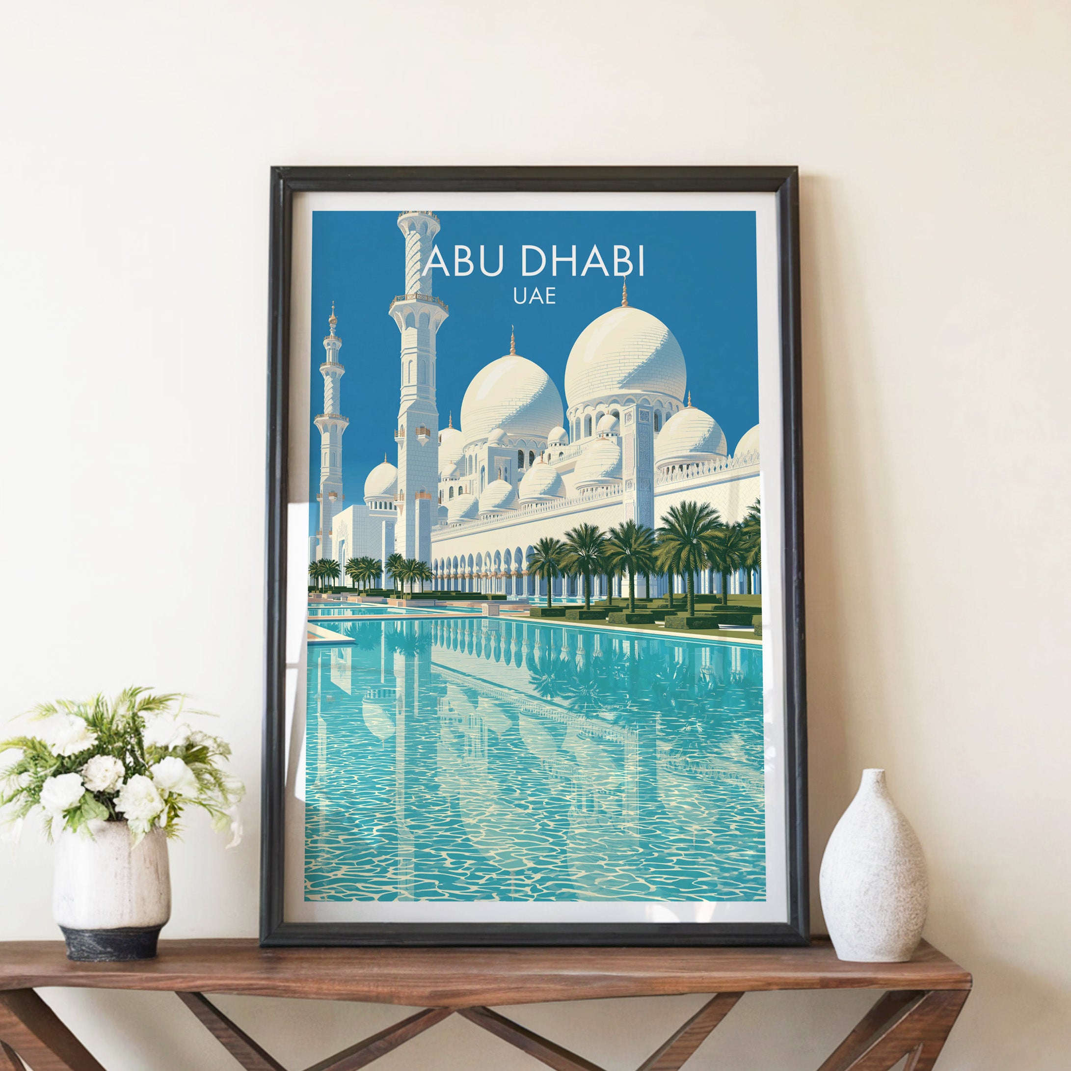Sheikh Zayed Mosque Abu Dhabi travel poster in a black frame on a wooden console table with white flowers
