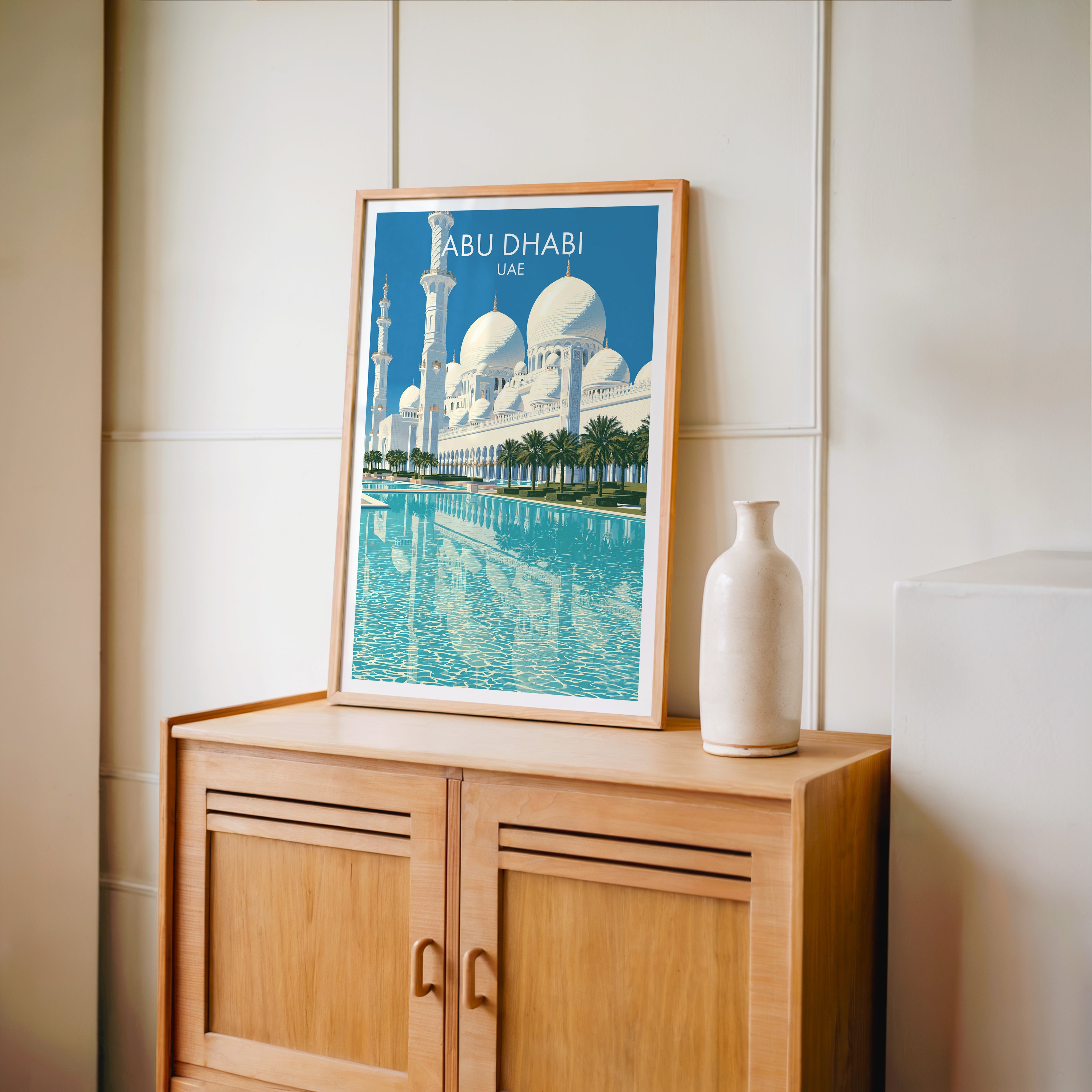 Small Sheikh Zayed Mosque Abu Dhabi travel poster in an oak frame on a mid-century sideboard with a ceramic vase