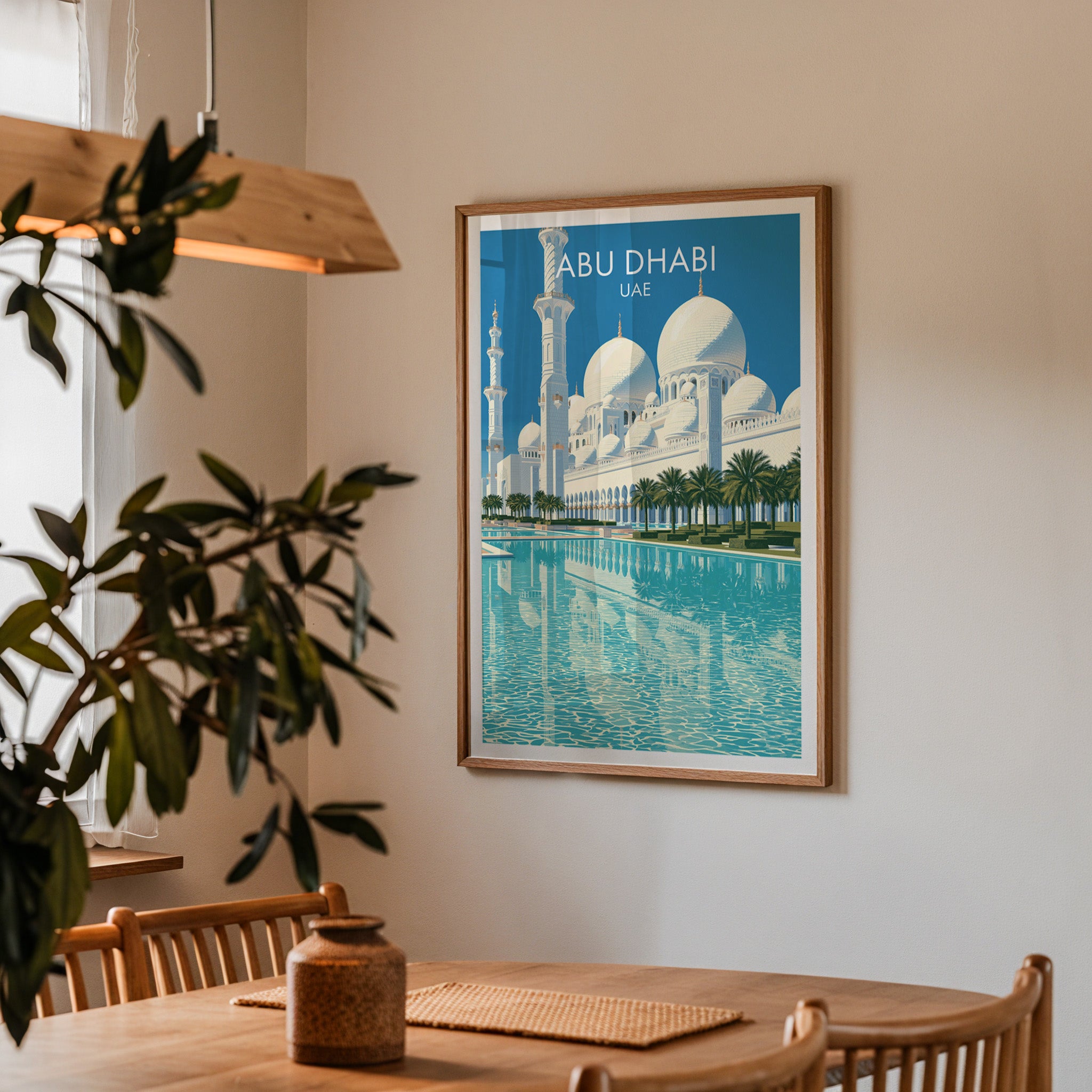 Framed Sheikh Zayed Mosque Abu Dhabi print on a dining room wall above an oak table in warm afternoon light