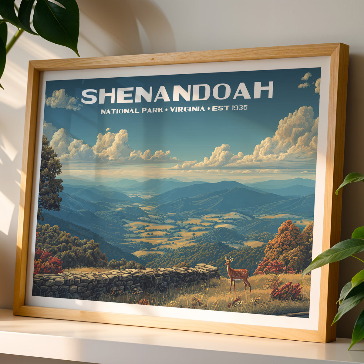 Shenandoah National Park wall art print in a light oak frame, leaning on a white shelf in warm sunlight beside a monstera plant