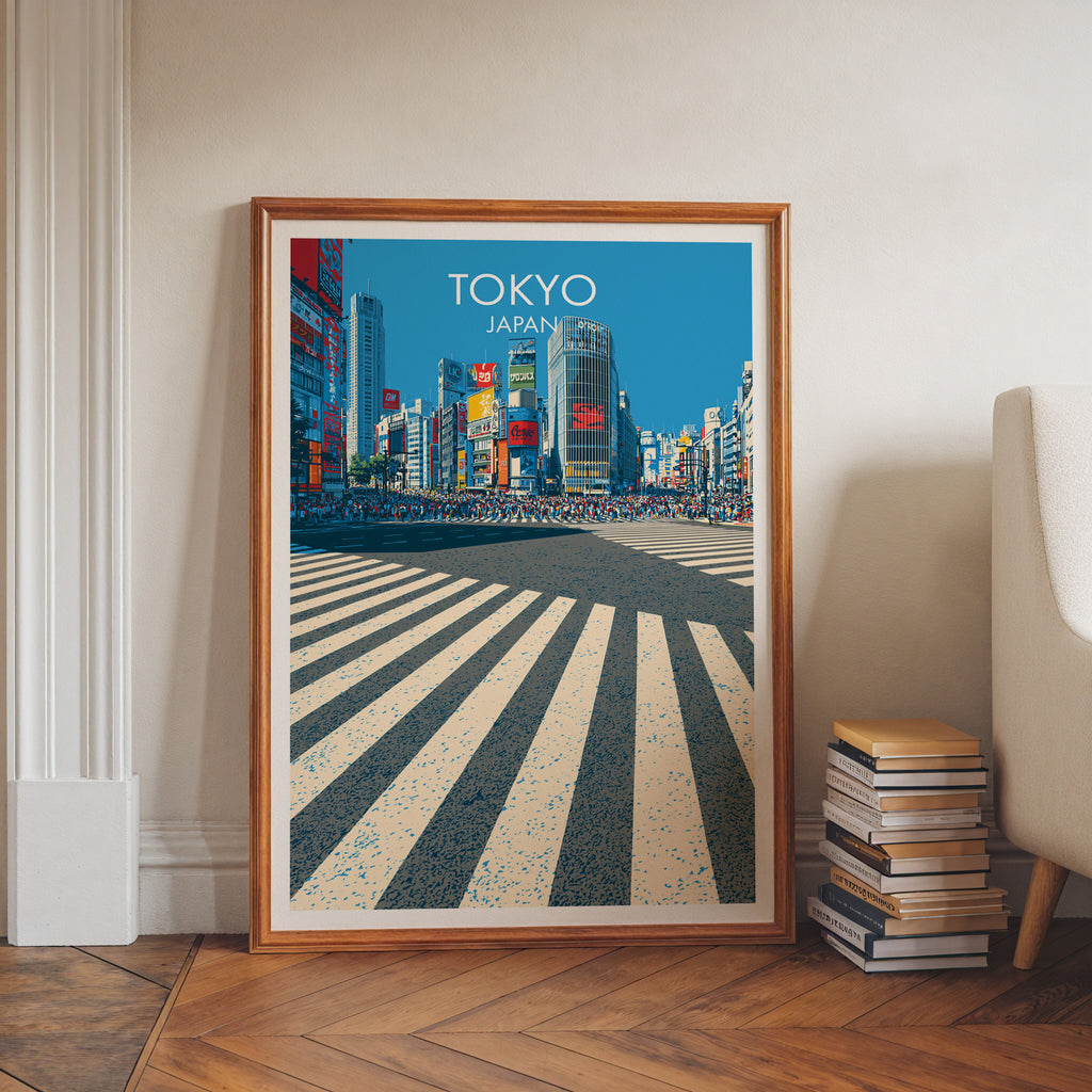 Shibuya Crossing Tokyo Japan art print in a walnut frame leaning in a hallway beside stacked books