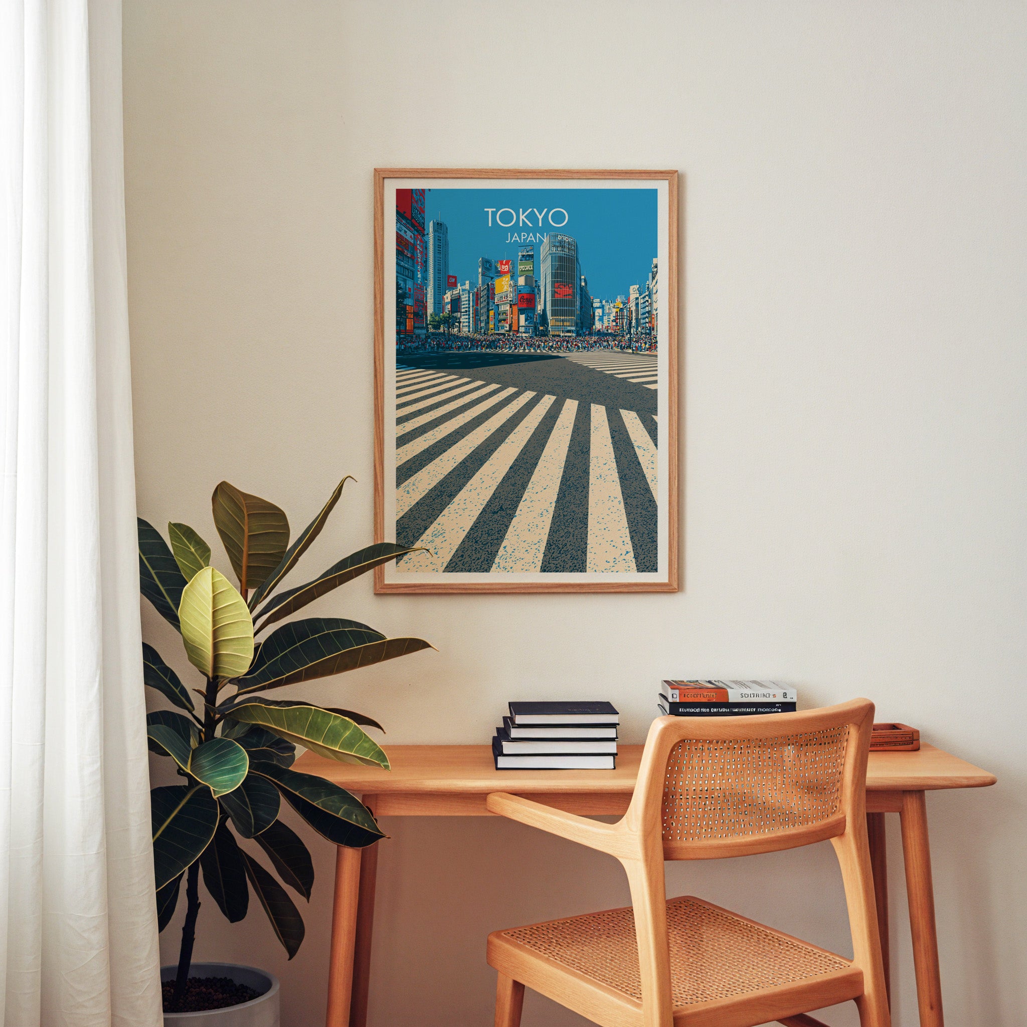 Shibuya Crossing Tokyo Japan wall art above a wooden home office desk with a rattan chair and books