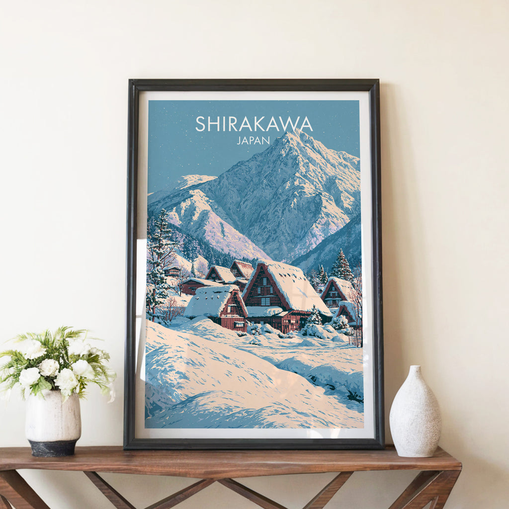 Shirakawa go Japan travel poster in a black frame on a wooden console table with white flowers