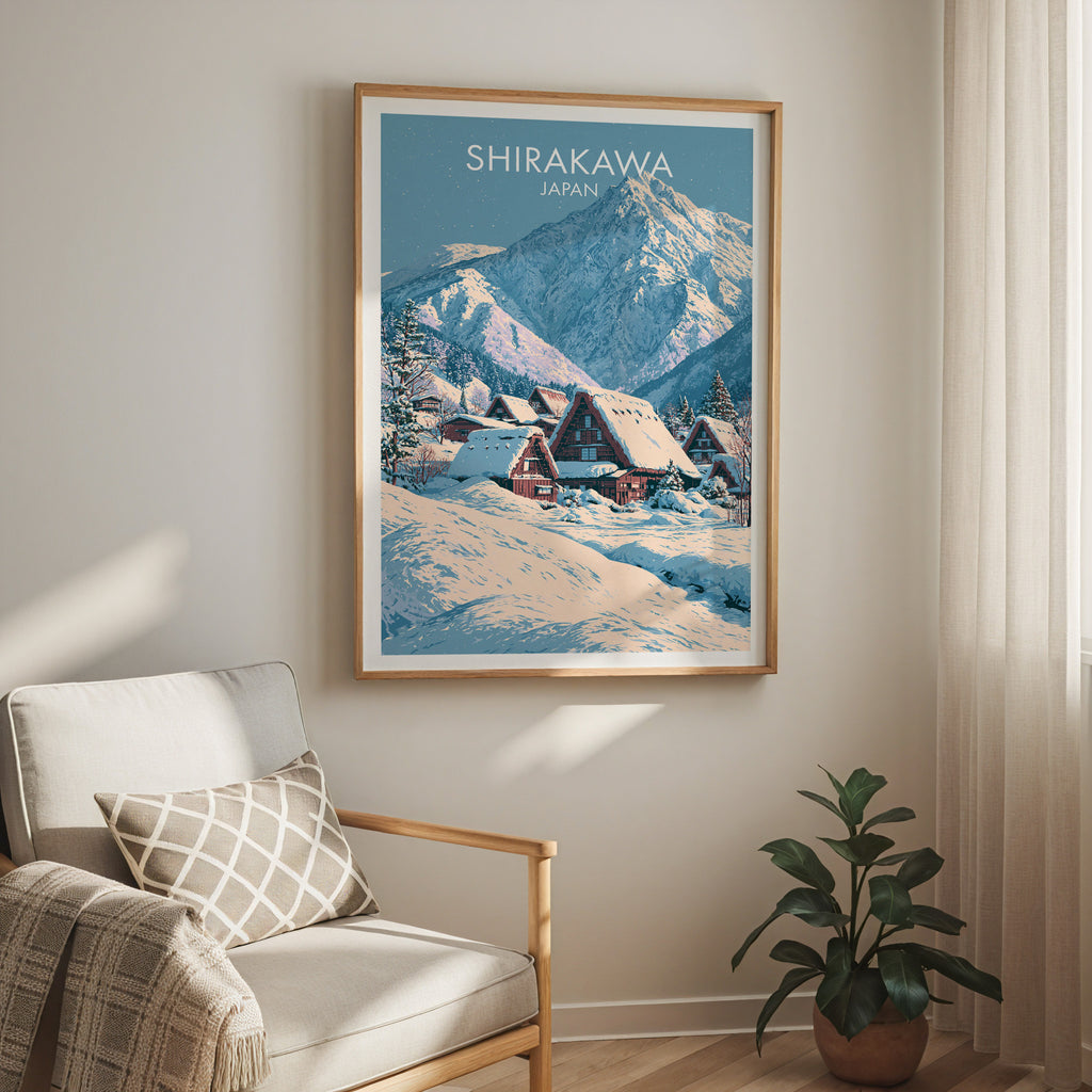 Shirakawa go Japan travel print in a light oak frame on a living room wall beside a linen armchair