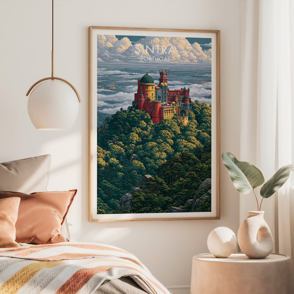Sintra Pena Palace poster in a large oak frame above a bed with rust bedding and a brass lamp