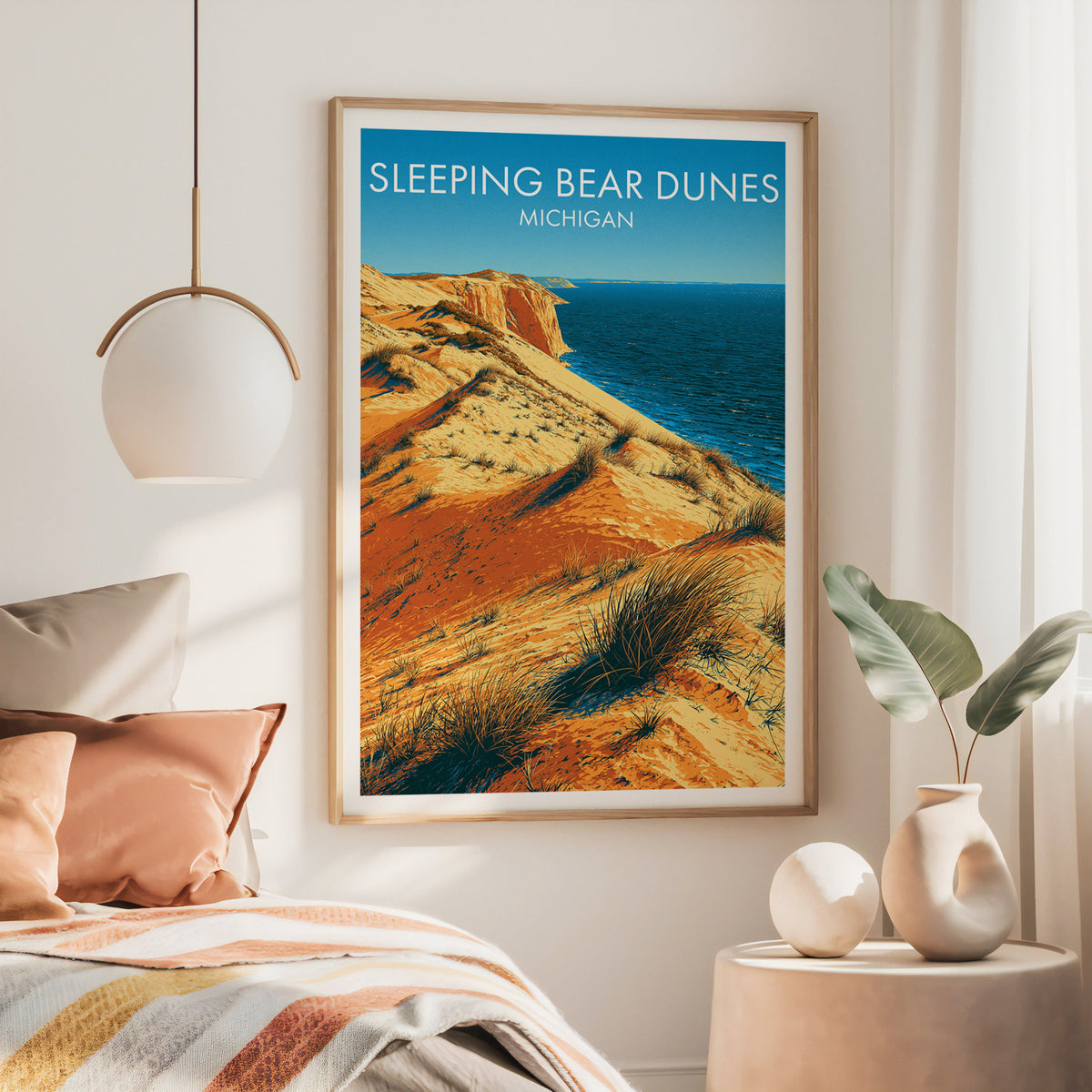Michigan travel art in a large oak frame above a bed with a rust iron headboard and brass pendant.