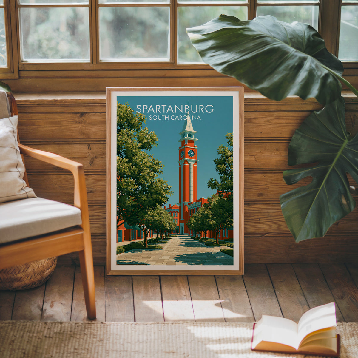 Clock tower wall art in an oak frame on a sunlit wood-grain wall by a mid-century armchair and rug