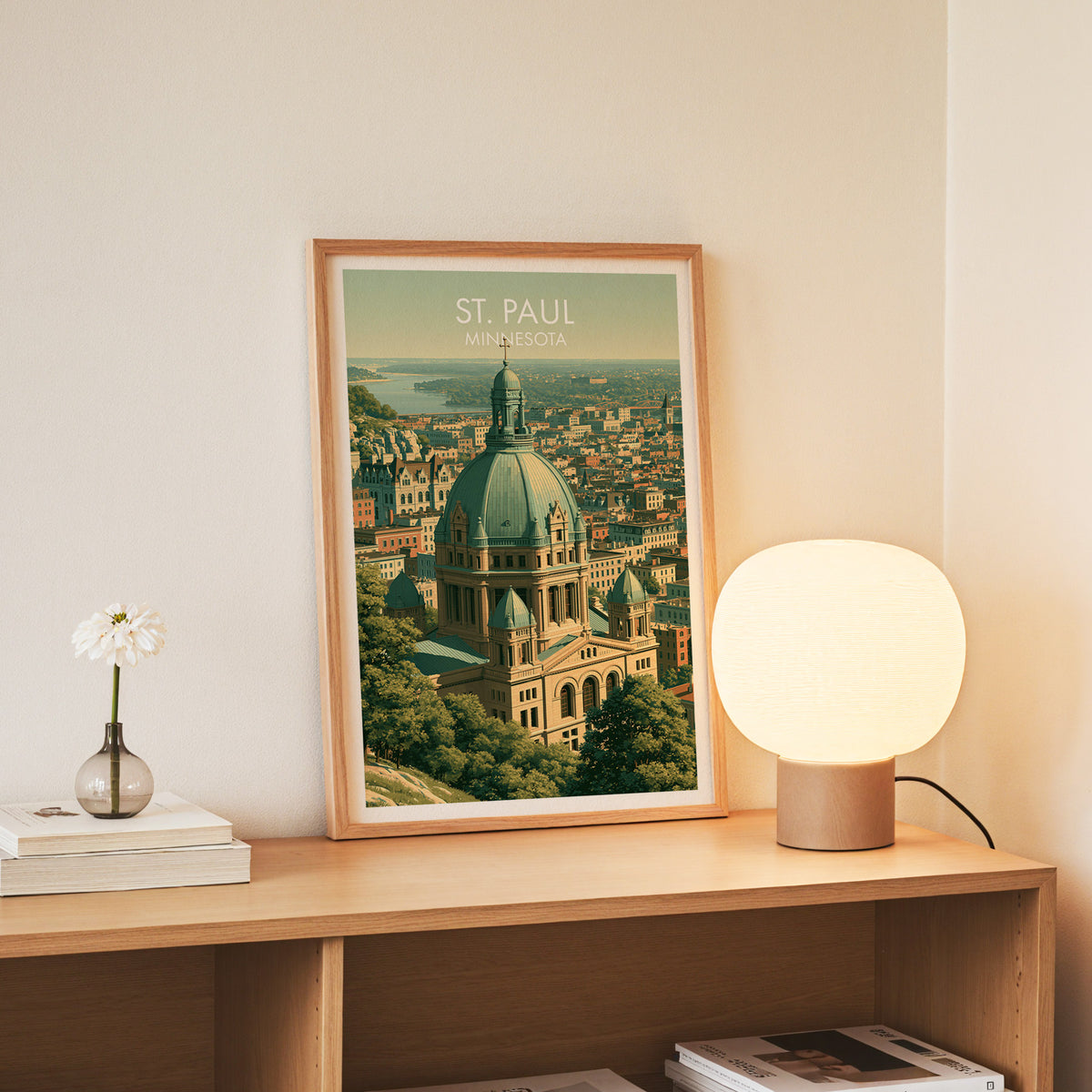 Slim oak framed St Paul print standing on a console beside white daisies in a glass jar