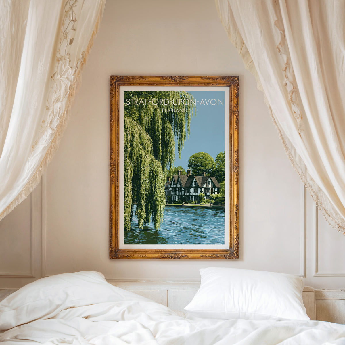 Stratford-upon-Avon poster, ornate gold frame above a white bed with linen canopy curtains