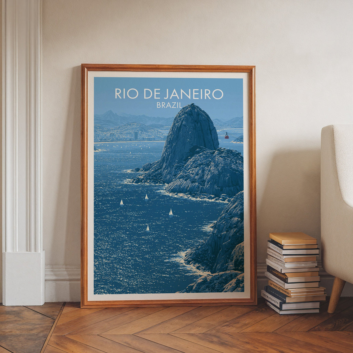 Cable car wall art in a walnut frame on a herringbone floor by white moulding, book stacks and a cream armchair