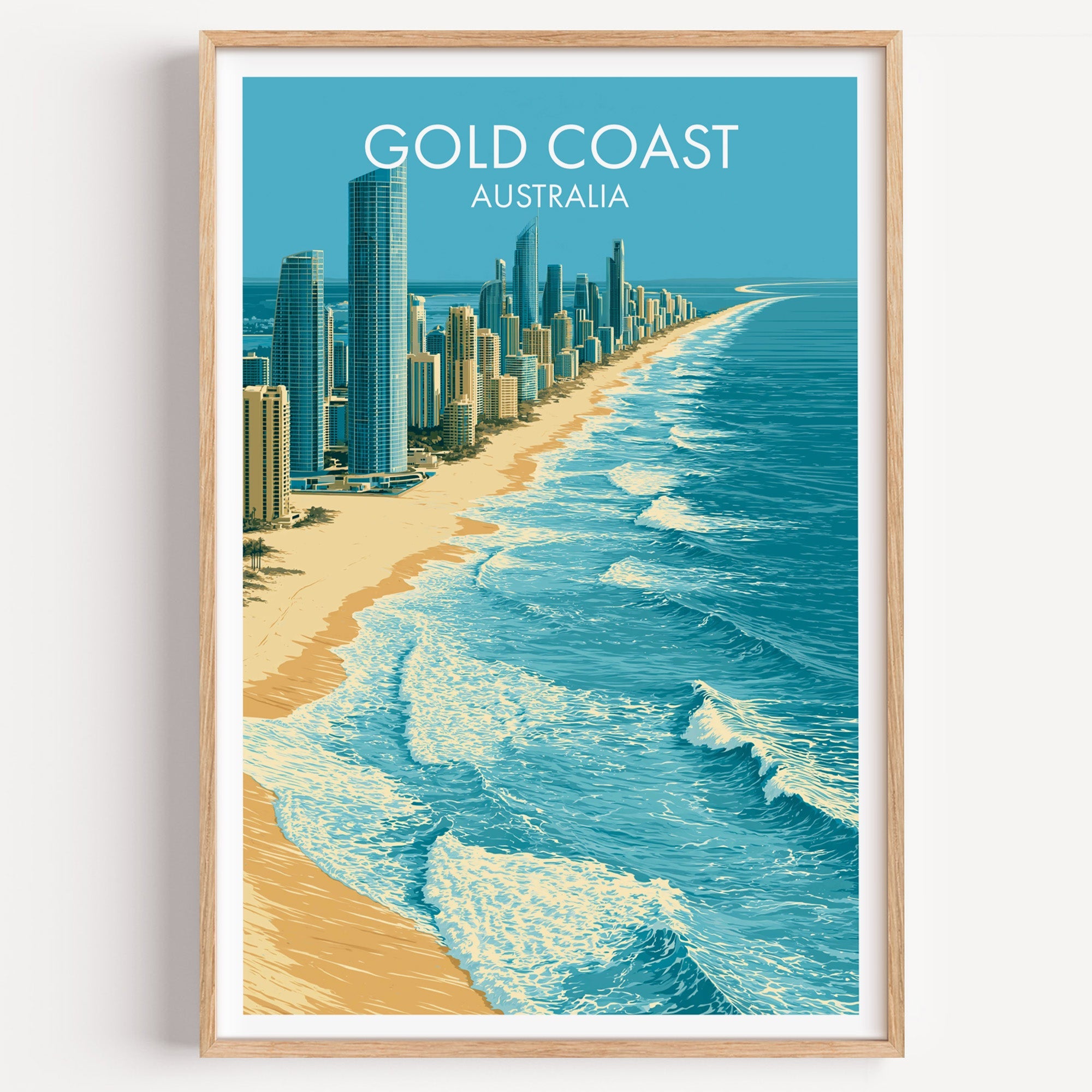 Surfers Paradise Gold Coast travel print in a light oak frame on a plain white wall