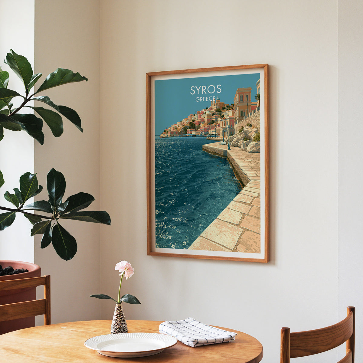Syros harbour promenade poster, walnut frame in a dining corner above a round table and a fiddle-leaf fig