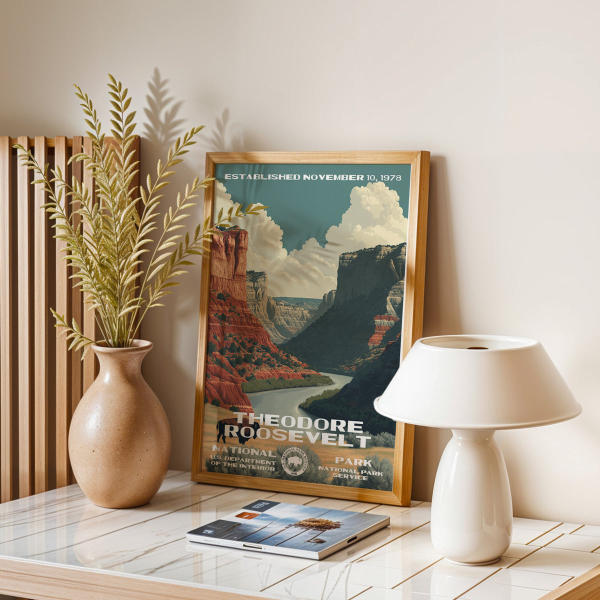 Theodore Roosevelt National Park vintage print leaning on a table with a ceramic lamp and dried grasses