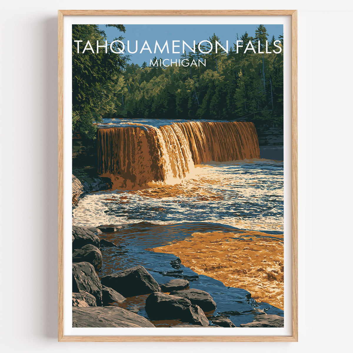 Tahquamenon Falls travel poster in a light oak frame on a plain white wall, soft shadow